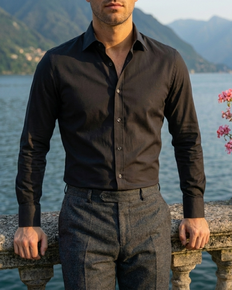 Men’s black slim fit button-up shirt styled with dark trousers