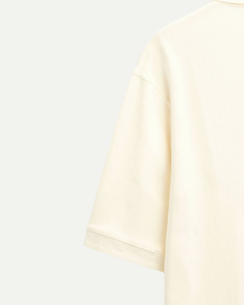 Men’s cream knit polo shirt sleeve detail