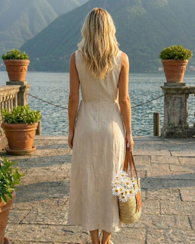Back view of beige linen sleeveless shirt dress with flowing A-line silhouette