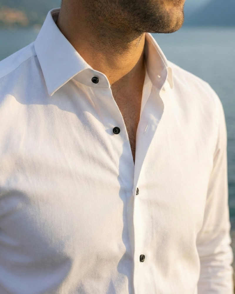 Close-up of men’s white slim fit dress shirt collar and buttons