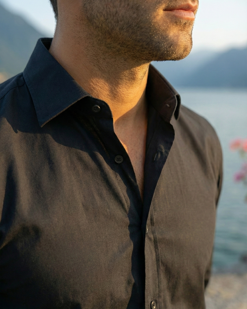 Close-up of men’s black slim fit button-up shirt collar and placket