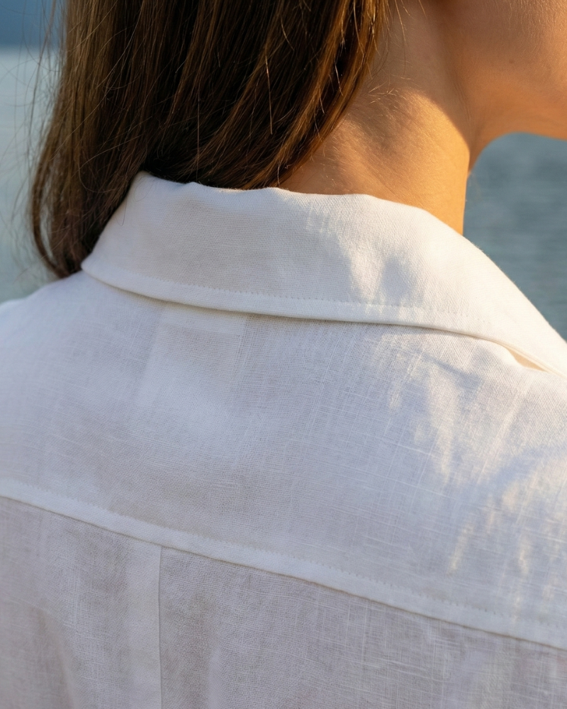 Close-up of white shirt dress collar and shoulder seam detail