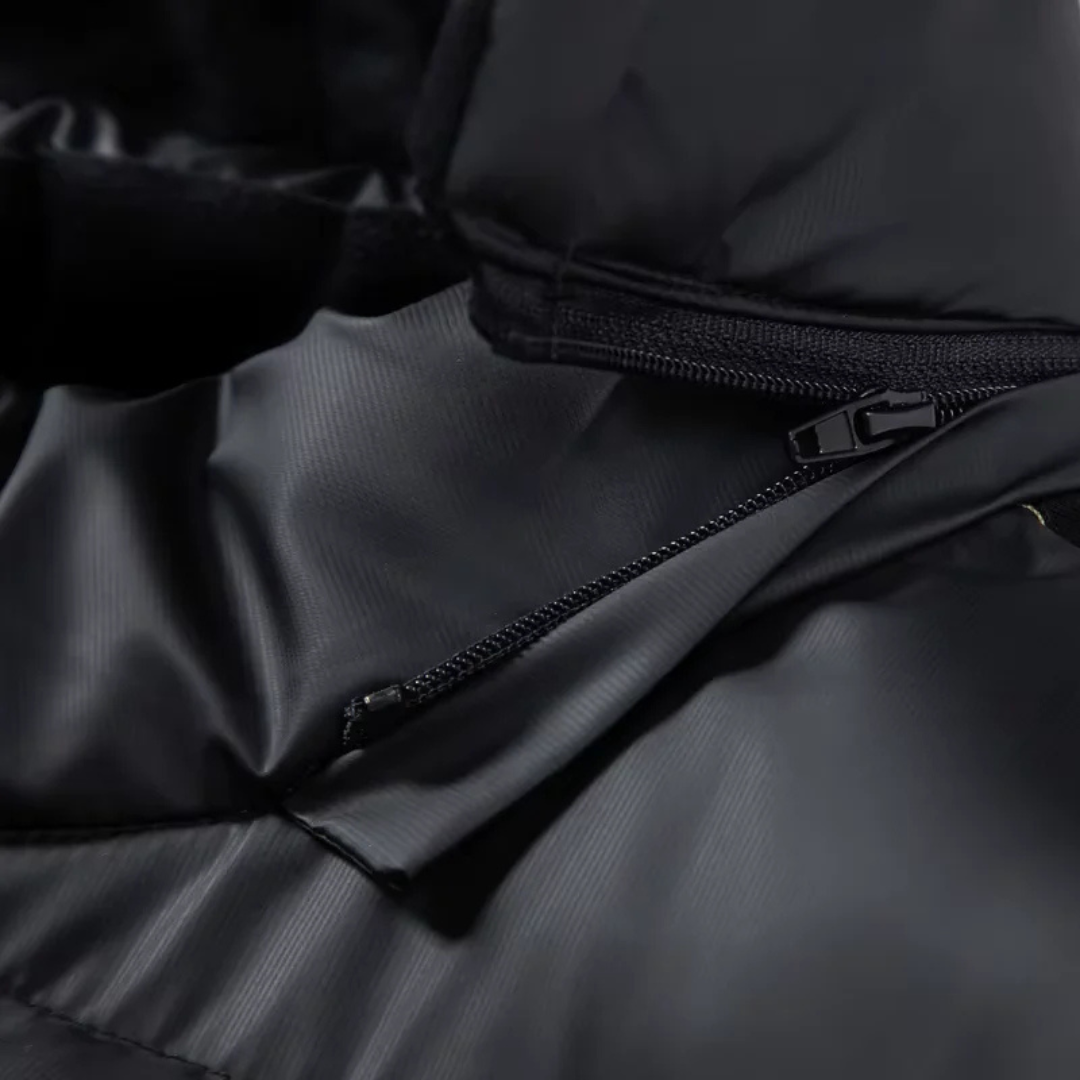 Close-up of the zipped chest pocket on the down puffer jacket — Aveloire