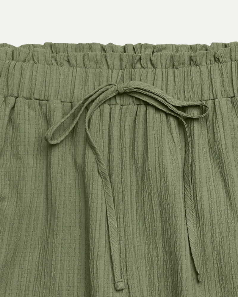 green wide leg trousers high waisted drawstring waist fabric texture close up
