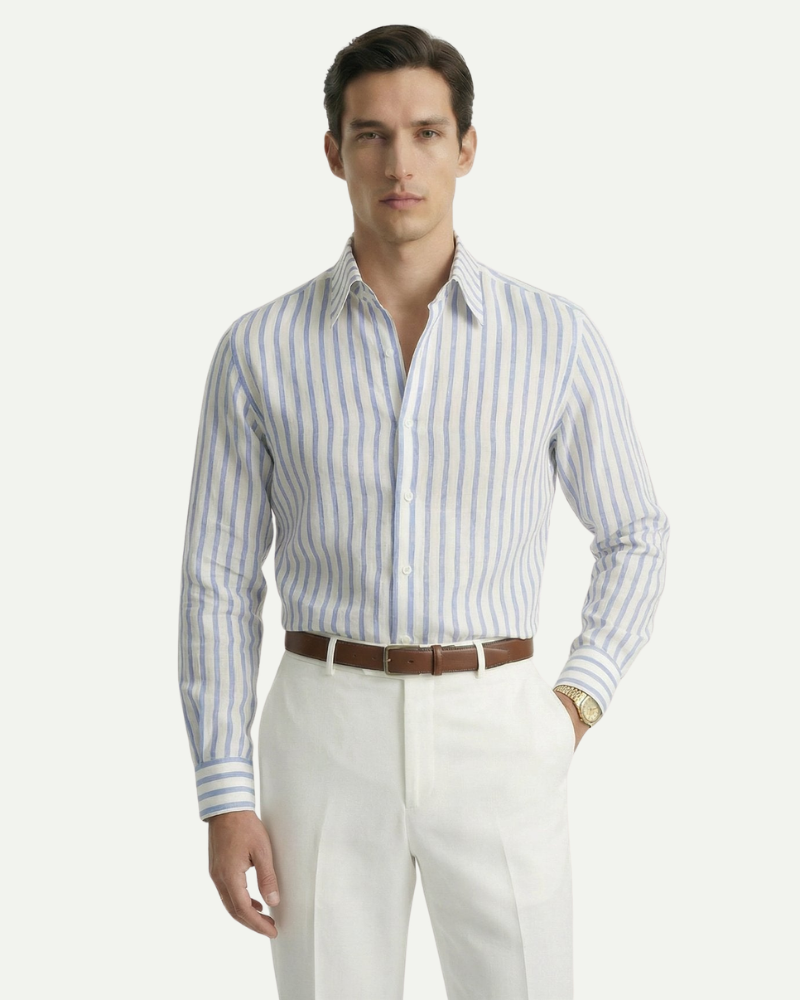 Male model wearing a blue striped linen button-up shirt in a refined summer outfit
