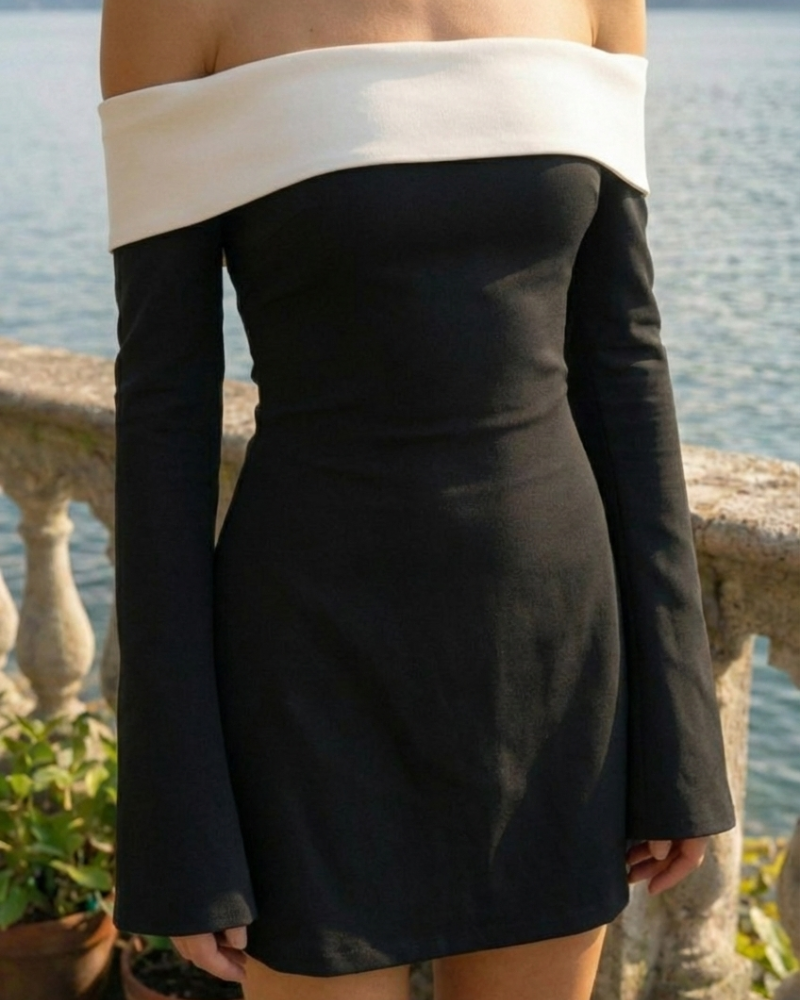 Close-up of black off-shoulder mini dress with contrast neckline and long sleeves
