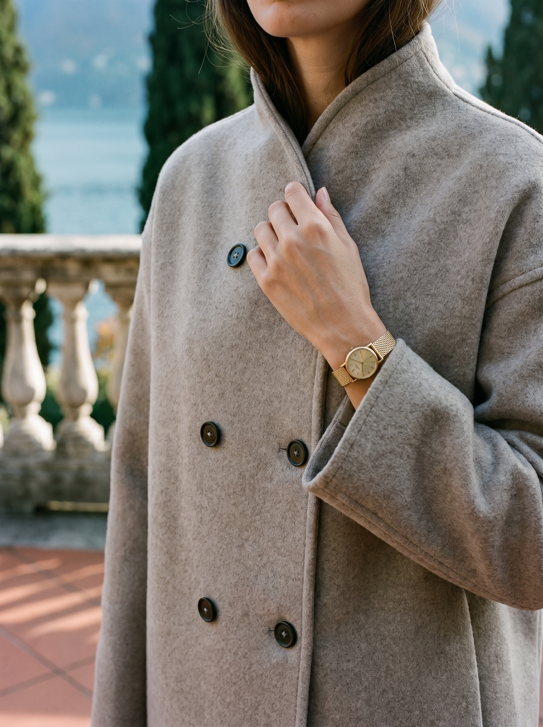 Close-up of the stand collar and buttons on the oatmeal wool coat — Aveloire