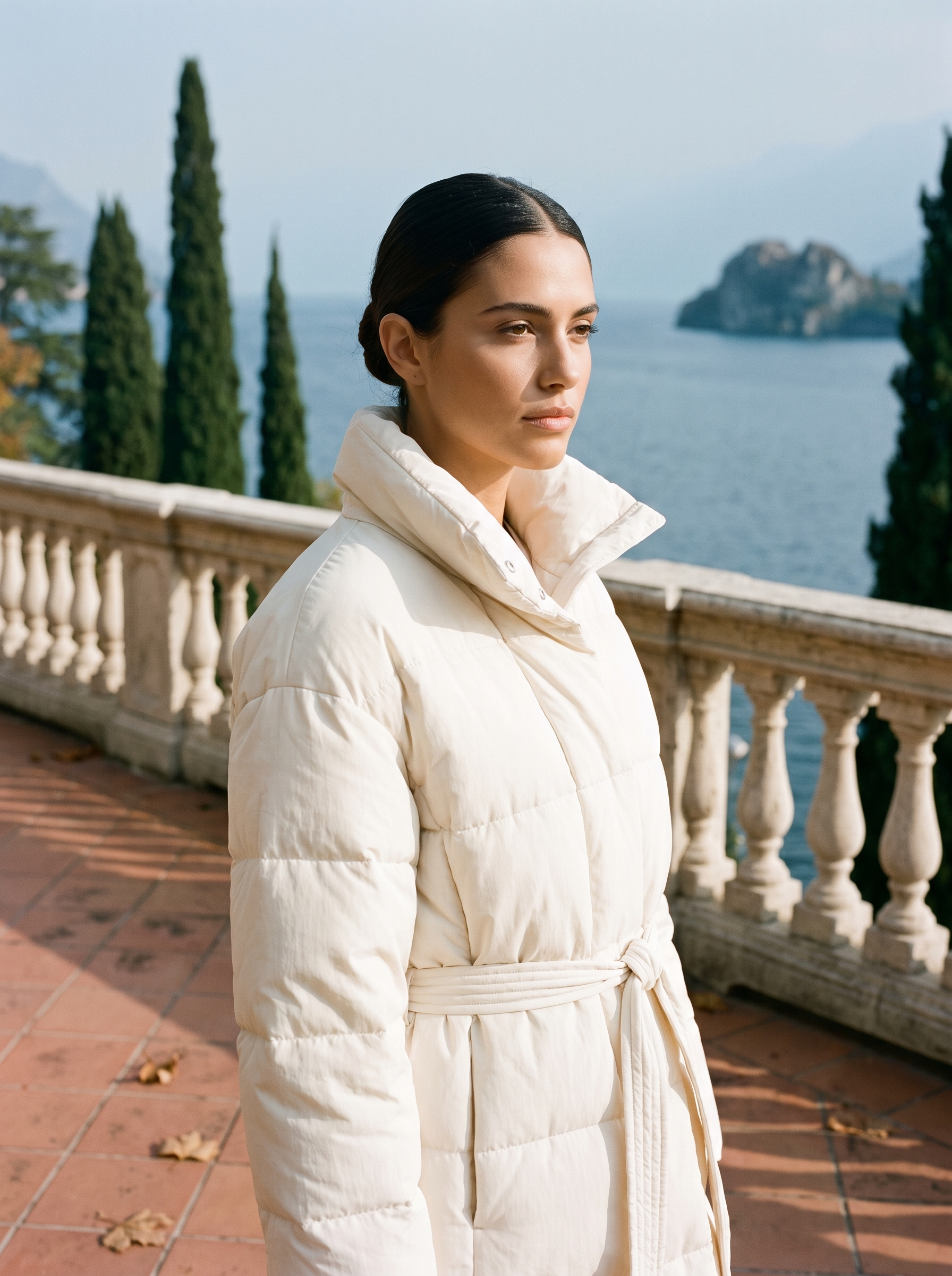 Cream belted quilted coat for women, worn on a Lake Como terrace — Aveloire