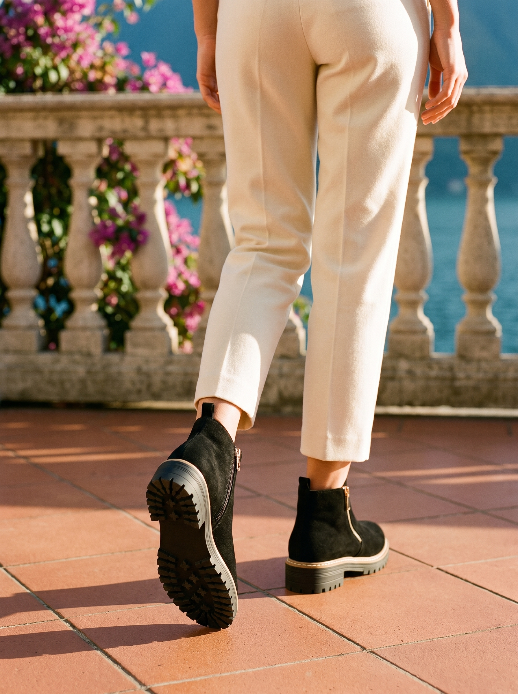 Back view of black lug sole ankle boots showing rear pull tab