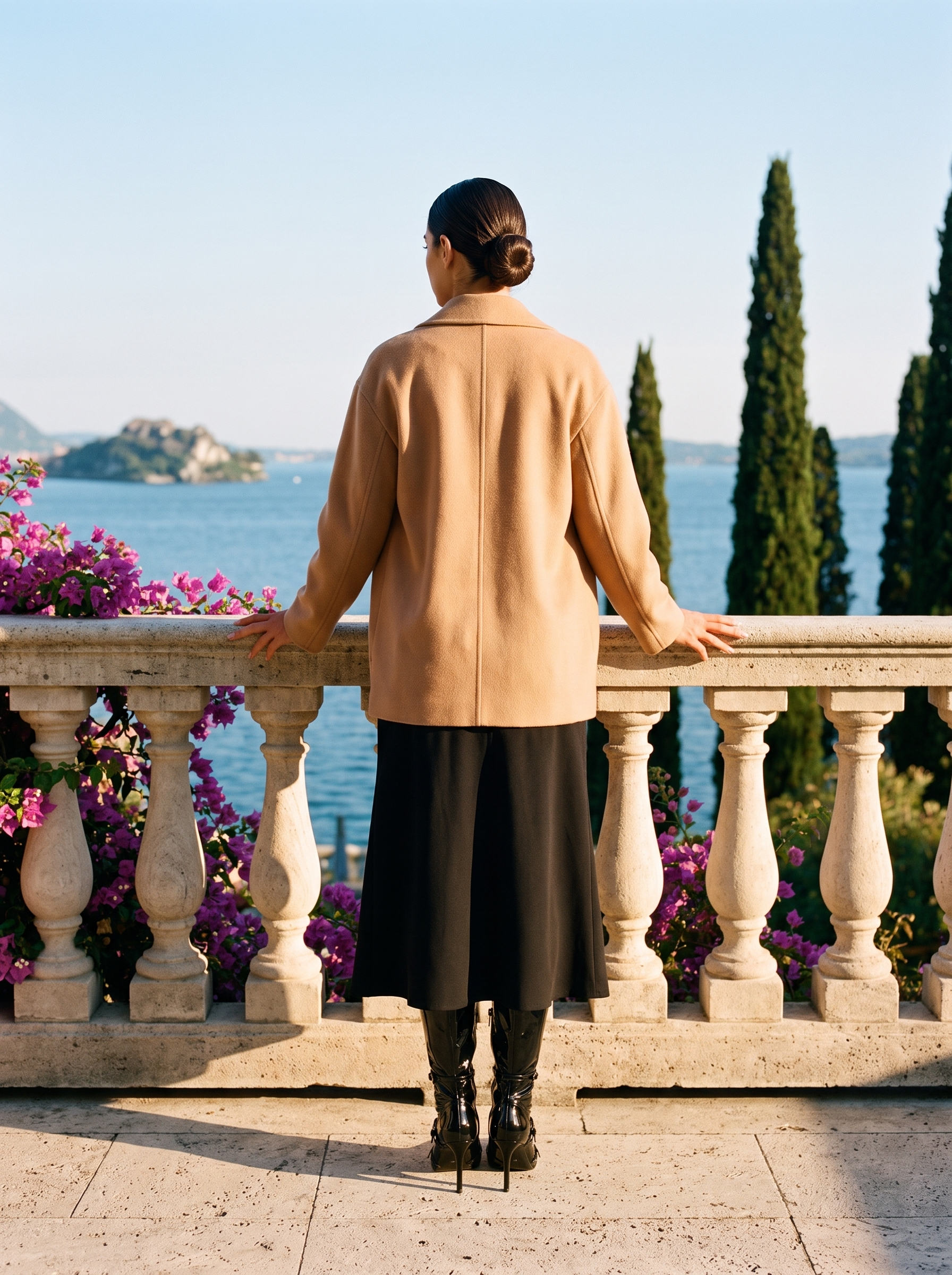 Back view of black patent stiletto knee high boots on a Lake Como terrace — Aveloire