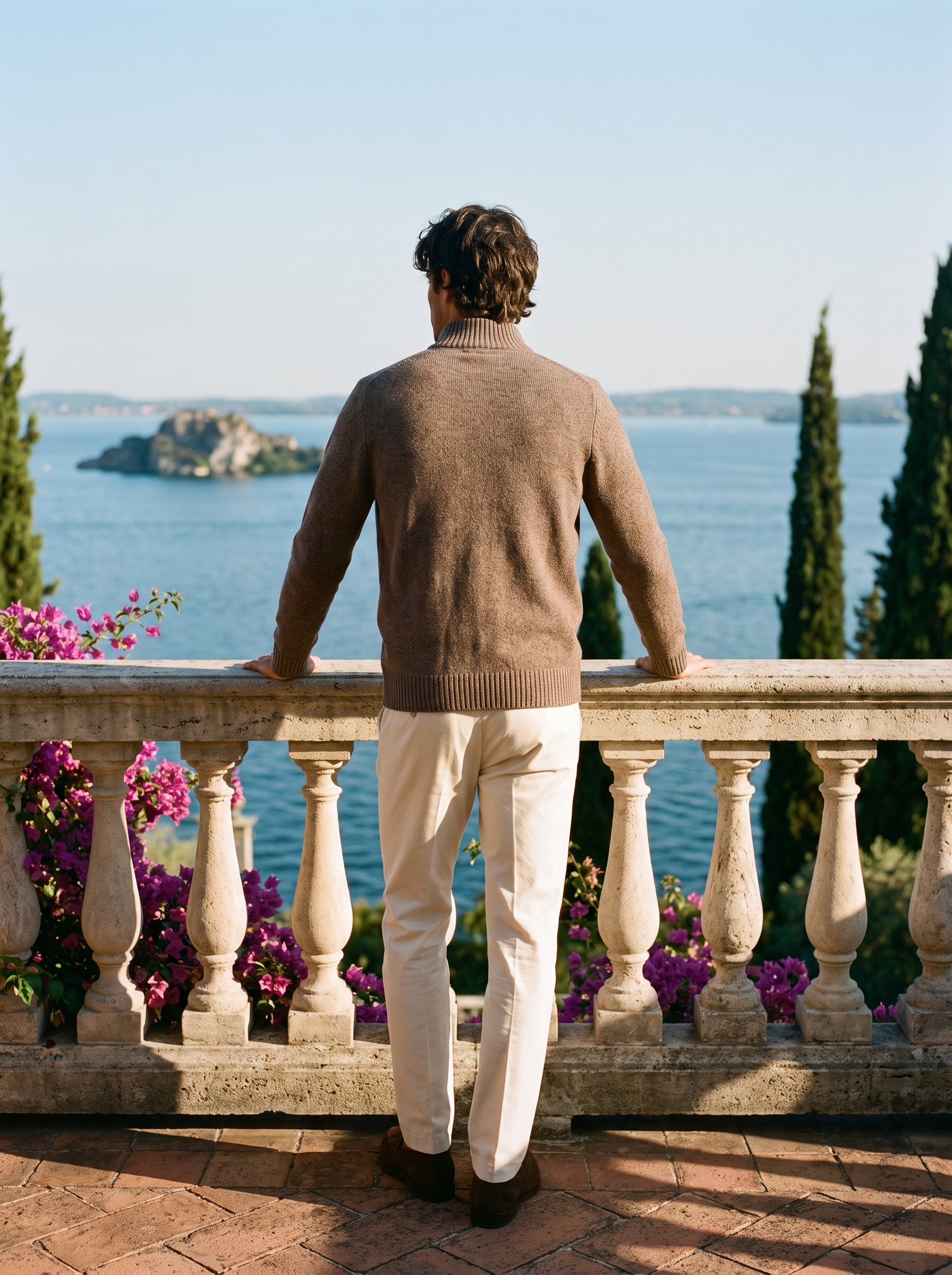 Back view of a brown melange zip-up stand collar cardigan worn on a Mediterranean terrace — Aveloire