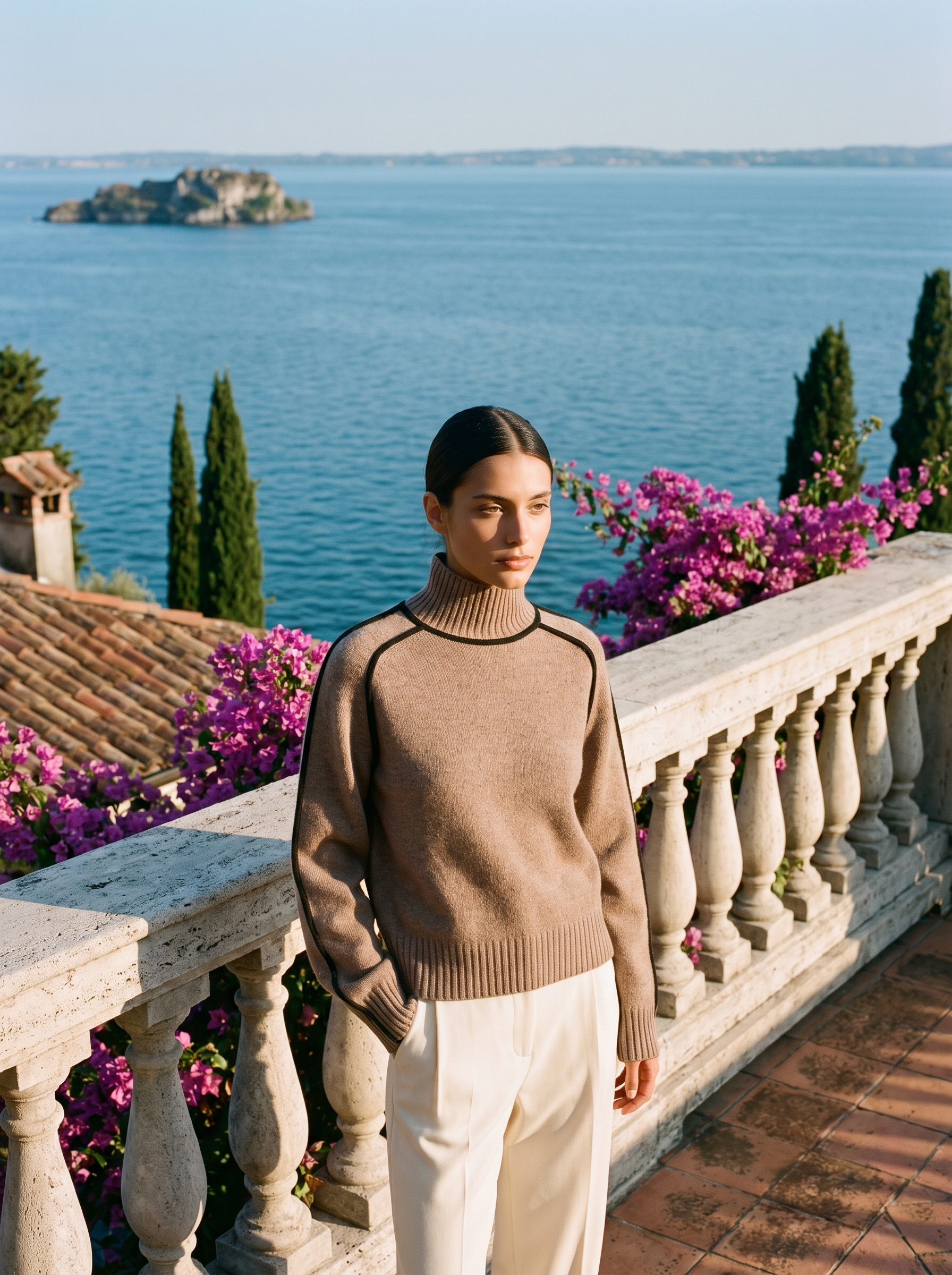 Woman in a brown turtleneck jumper, full-length front view on a Lake Como terrace — Aveloire
