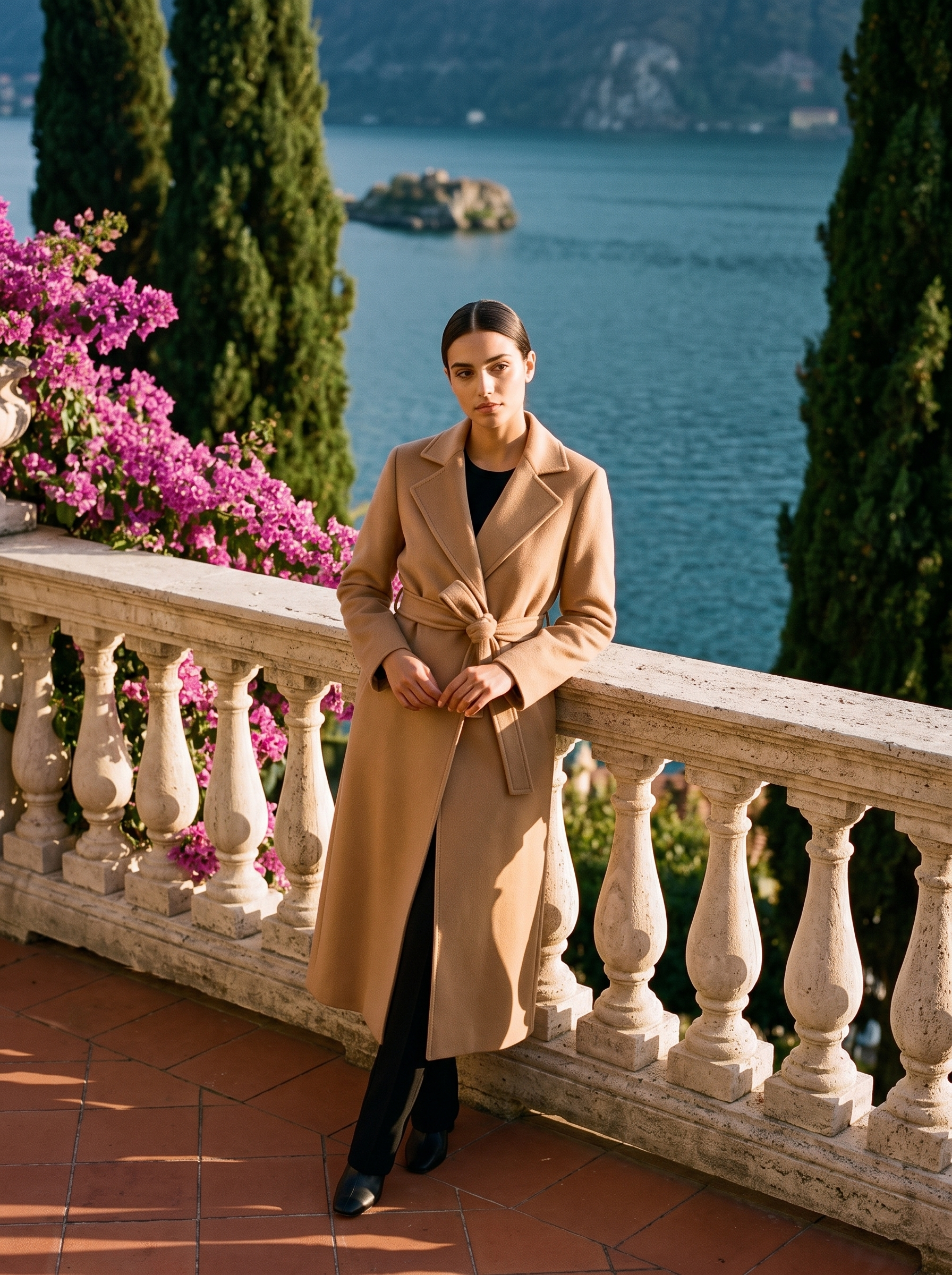 Full-length front view of a camel wool wrap coat on a Lake Como terrace — Aveloire