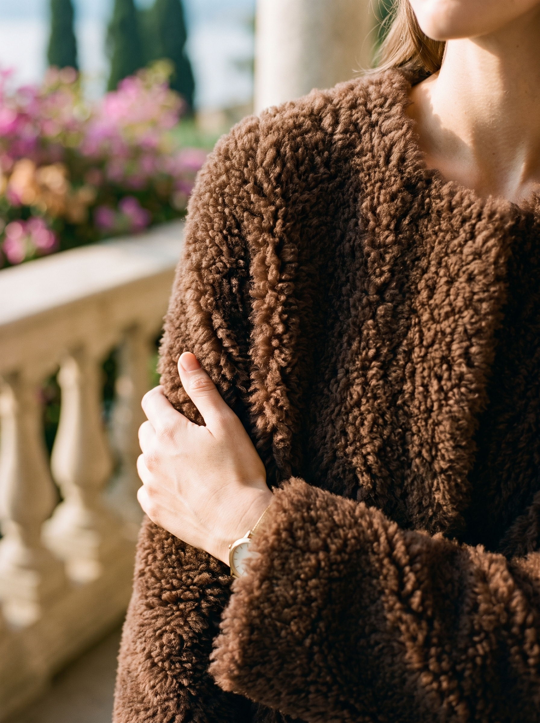 Close-up of the curly shearling texture on a coffee-brown teddy coat — Aveloire