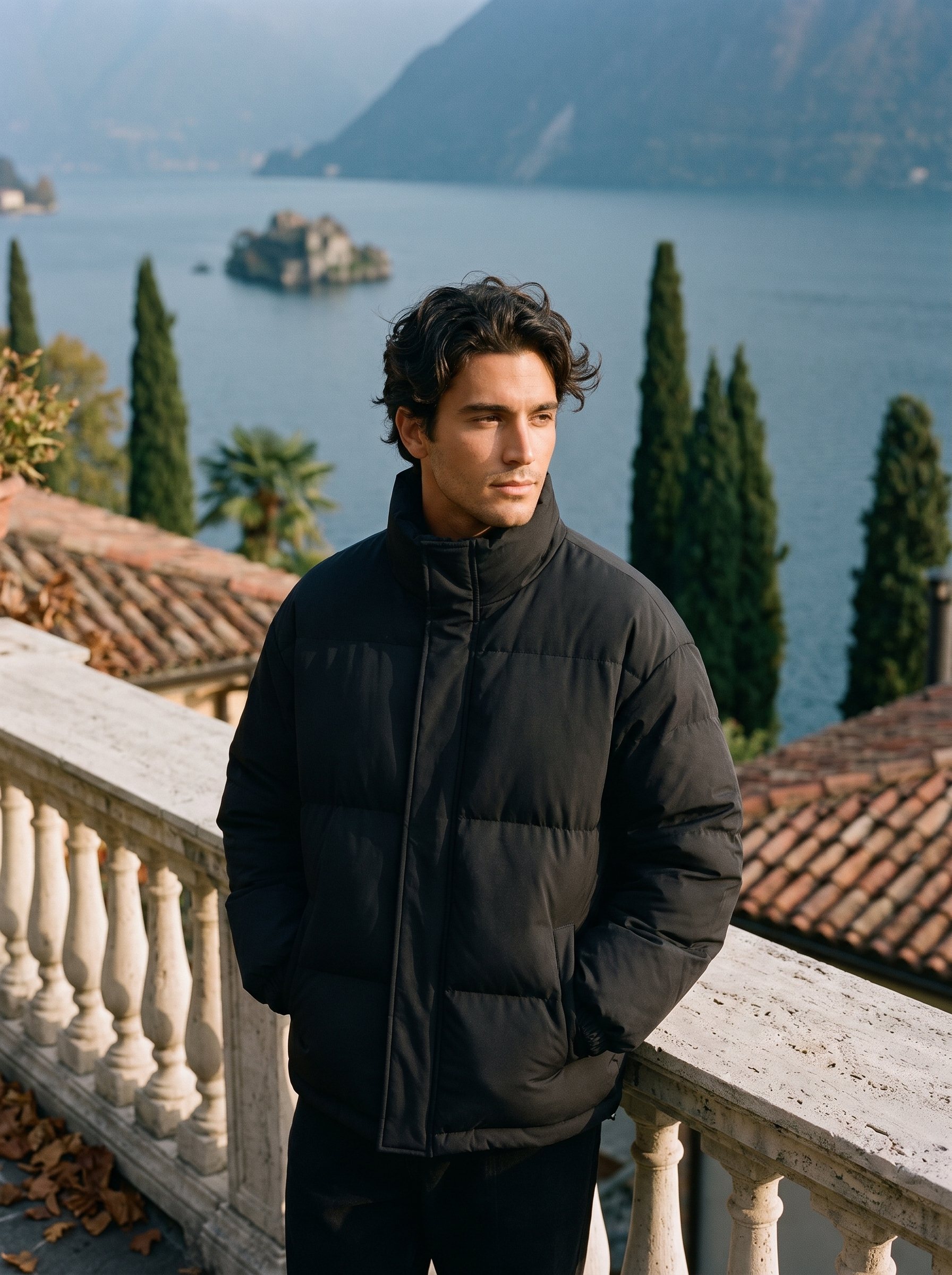 Black puffer jacket for men, worn on a Lake Como terrace — Aveloire