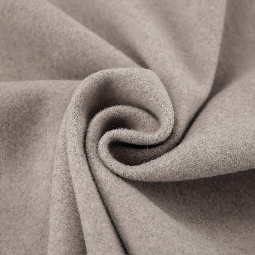 Close-up of the soft oatmeal wool texture on the double breasted coat — Aveloire