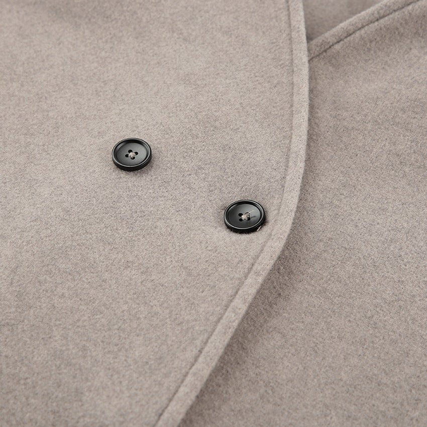 Close-up of the dark buttons on the oatmeal double breasted wool coat — Aveloire
