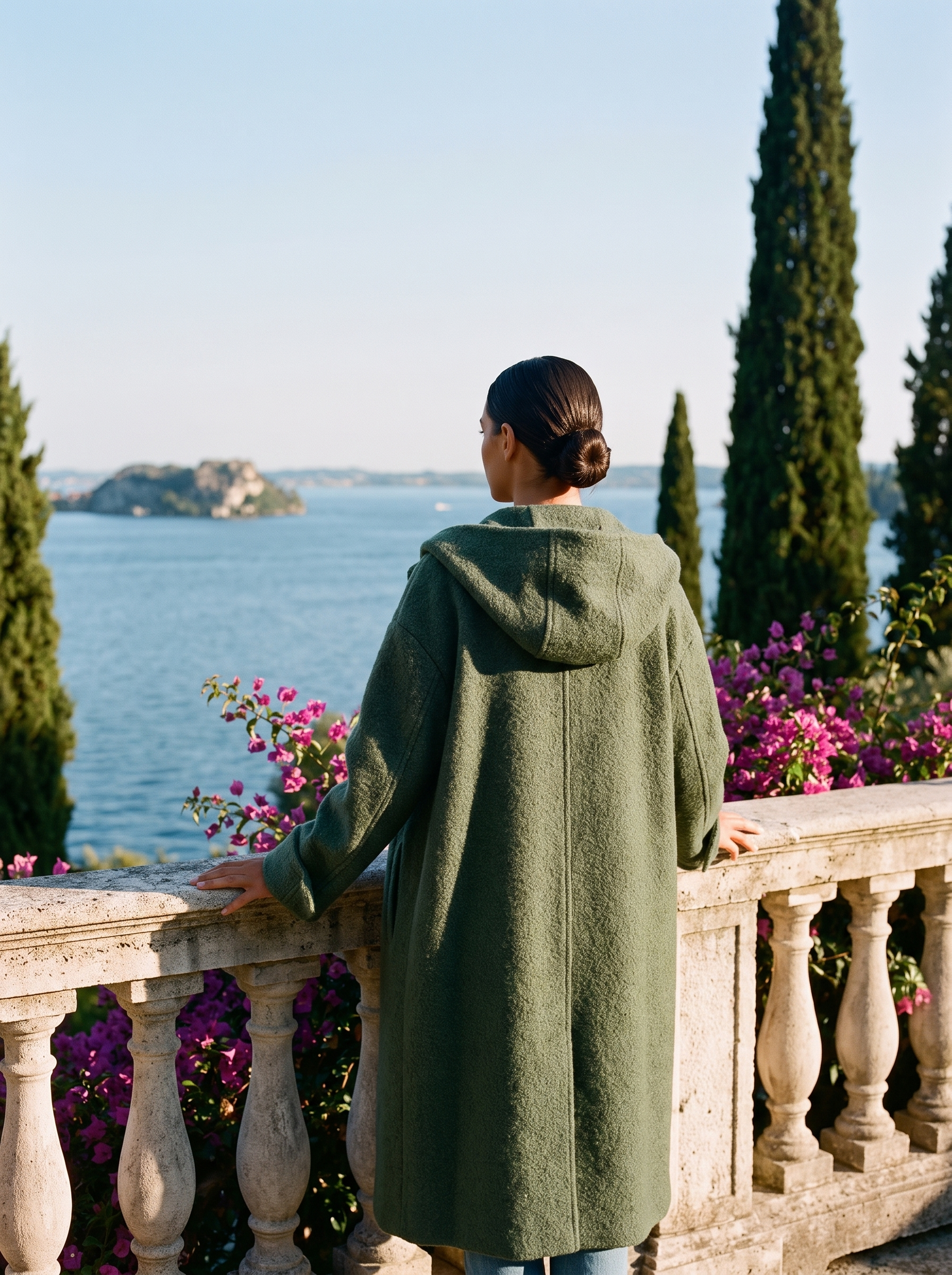 Back view of a green hooded wool coat on a Lake Como terrace — Aveloire