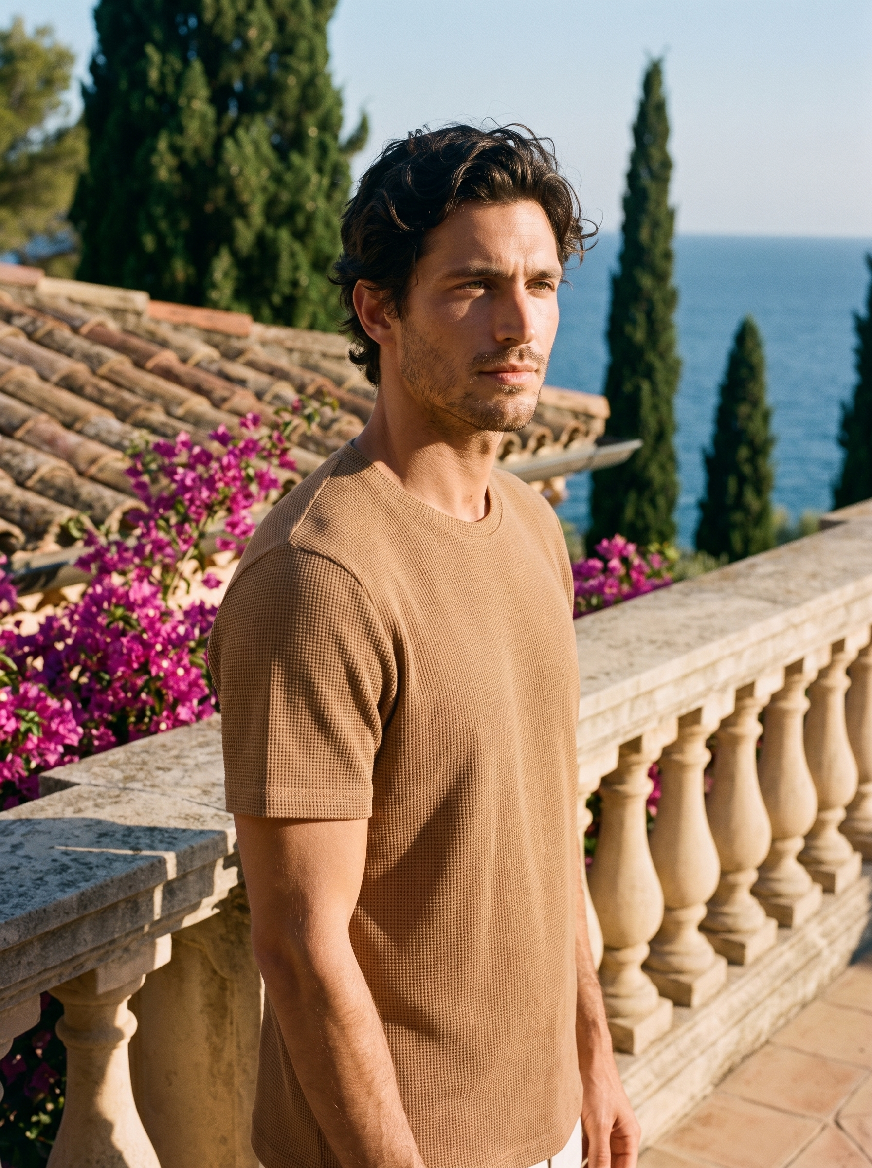 Man wearing a camel waffle knit tee on a balcony overlooking Lake Como, old money style — Aveloire