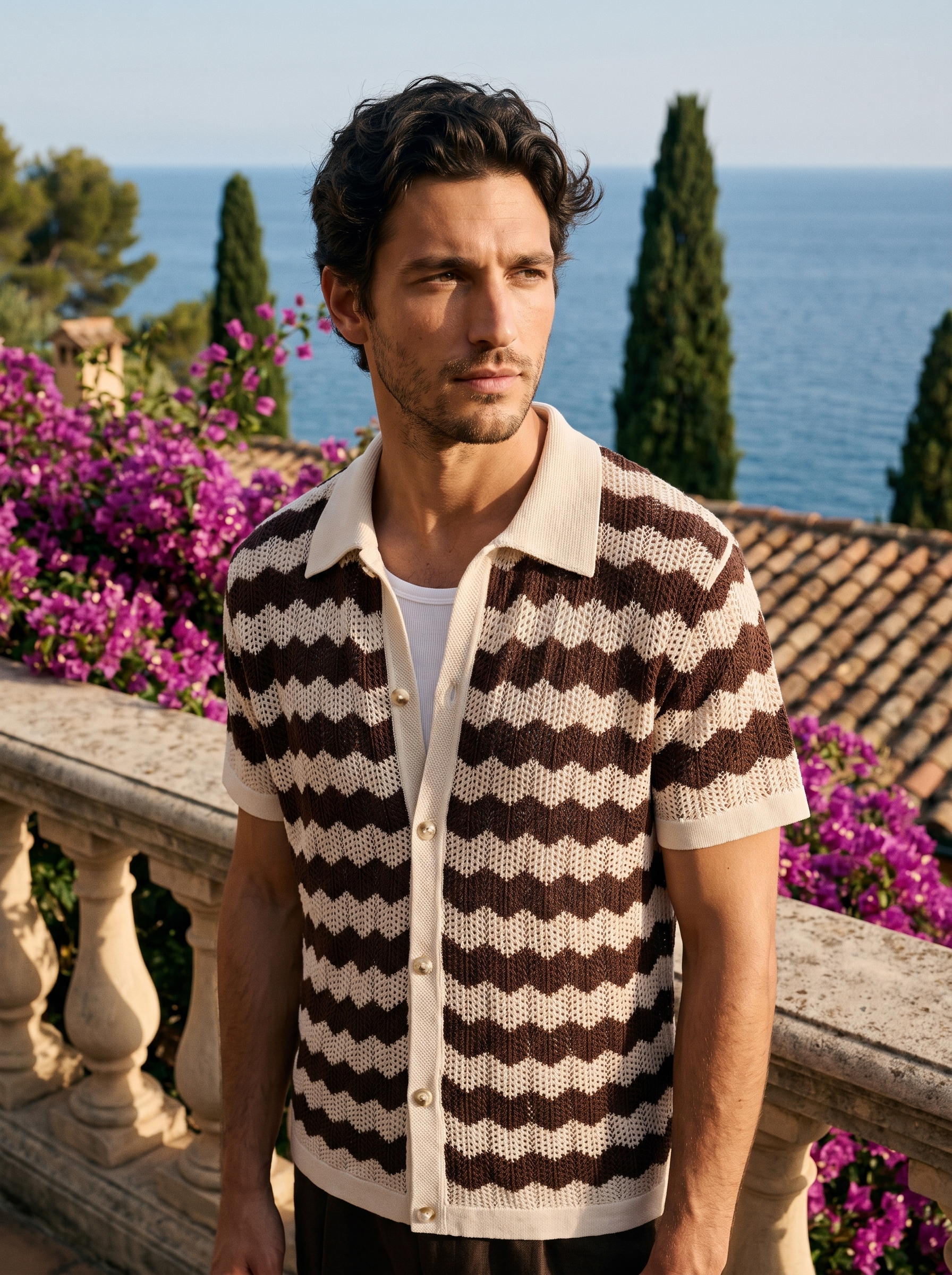 Man wearing a brown and cream wave knit button shirt on a balcony overlooking Lake Como, old money style — Aveloire
