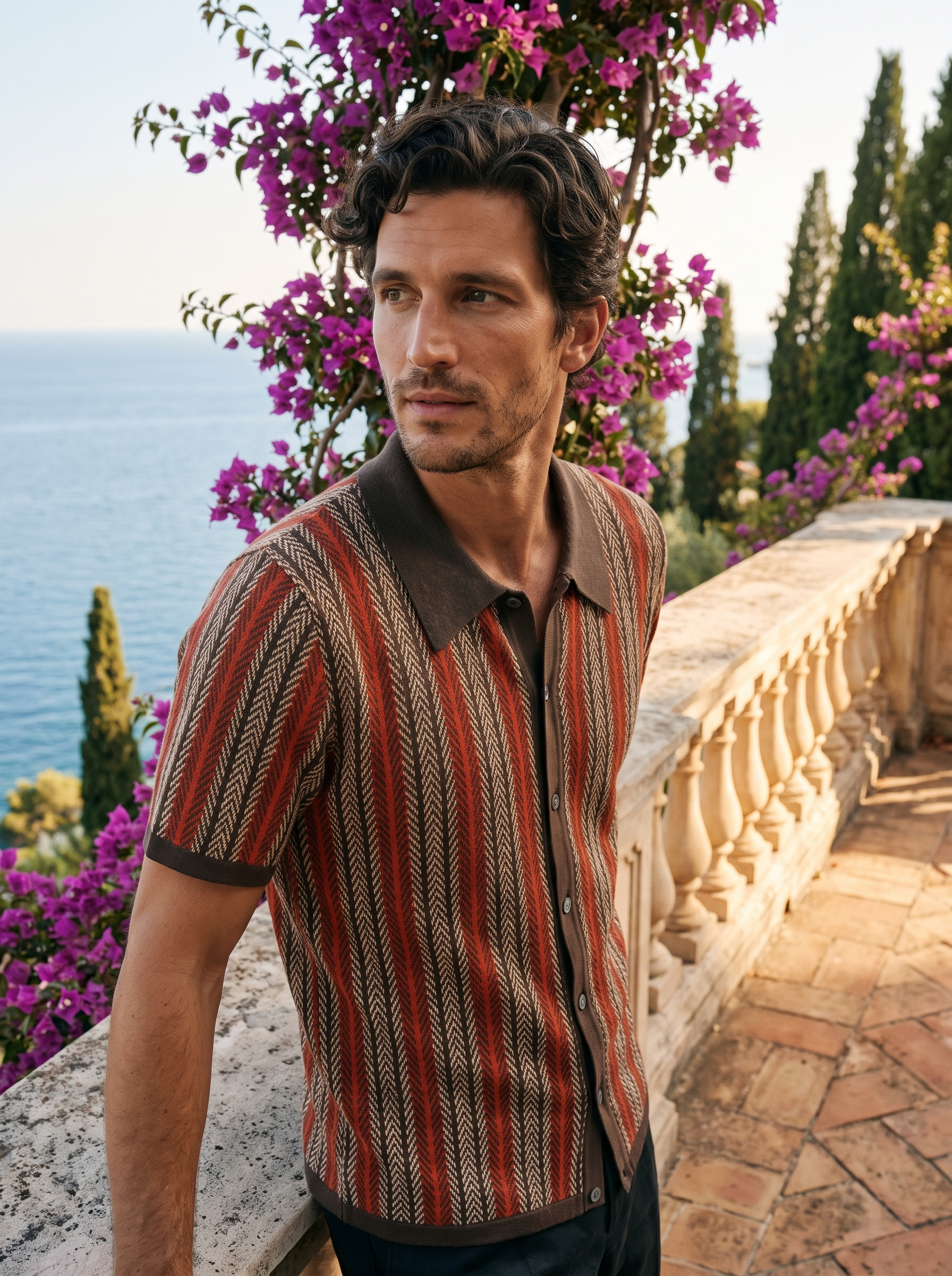Man wearing a brown striped knit button polo on a balcony overlooking Lake Como, old money style — Aveloire
