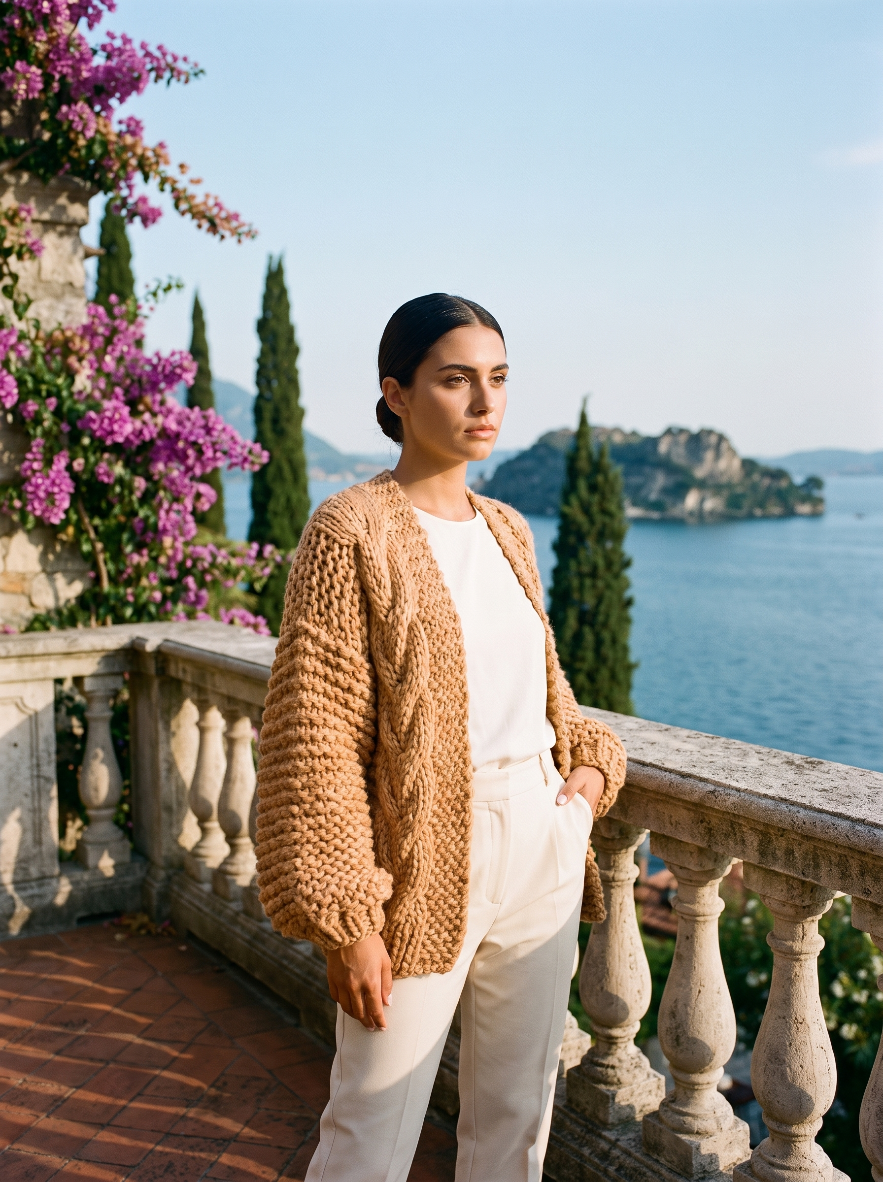 Full-length view of a camel chunky knit open-front cardigan on a Lake Como terrace — Aveloire