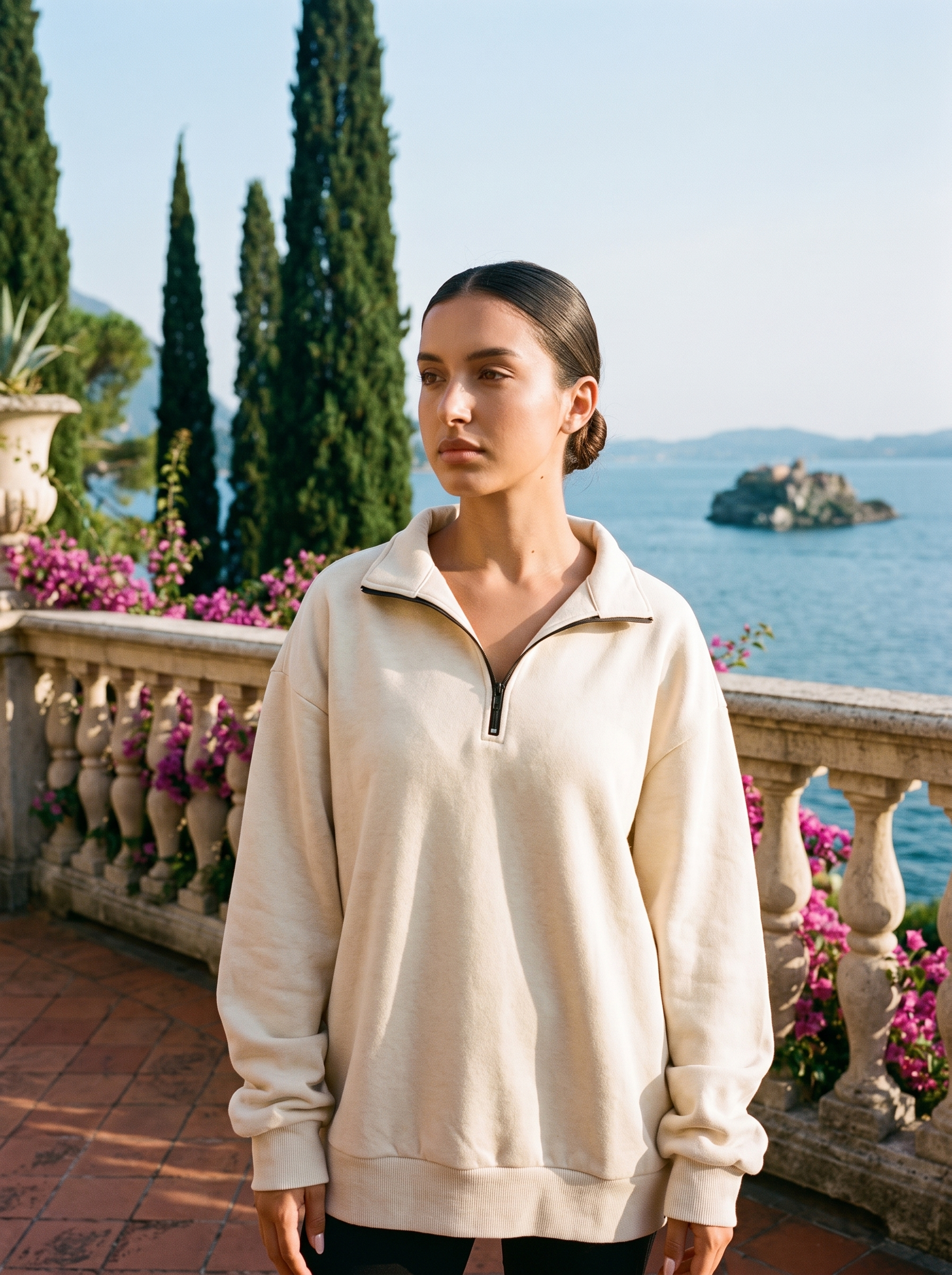 Woman wearing a cream half-zip oversized sweatshirt on a Lake Como terrace, old money style — Aveloire