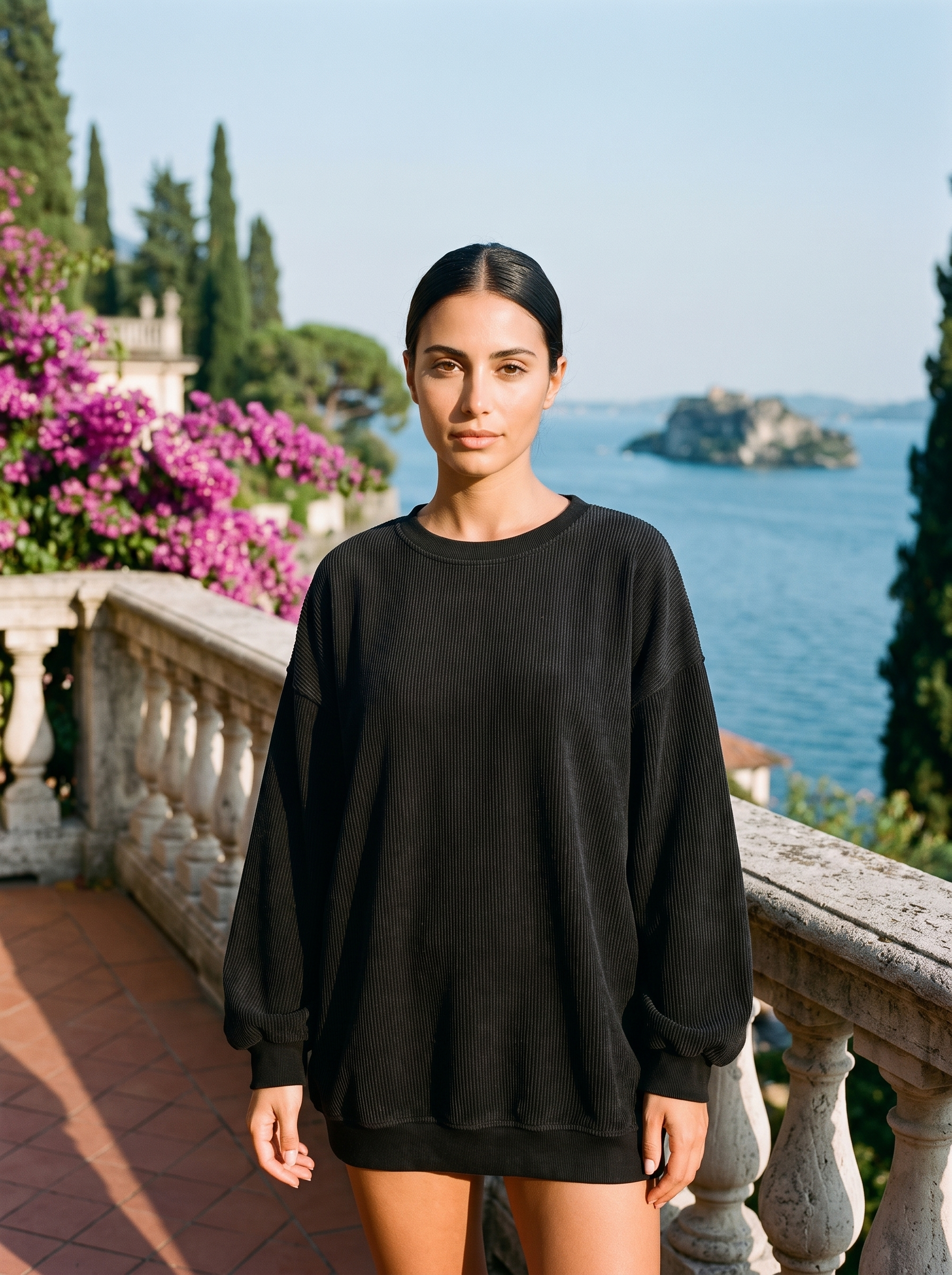 Woman wearing a black corded oversized sweatshirt on a Lake Como terrace — Aveloire