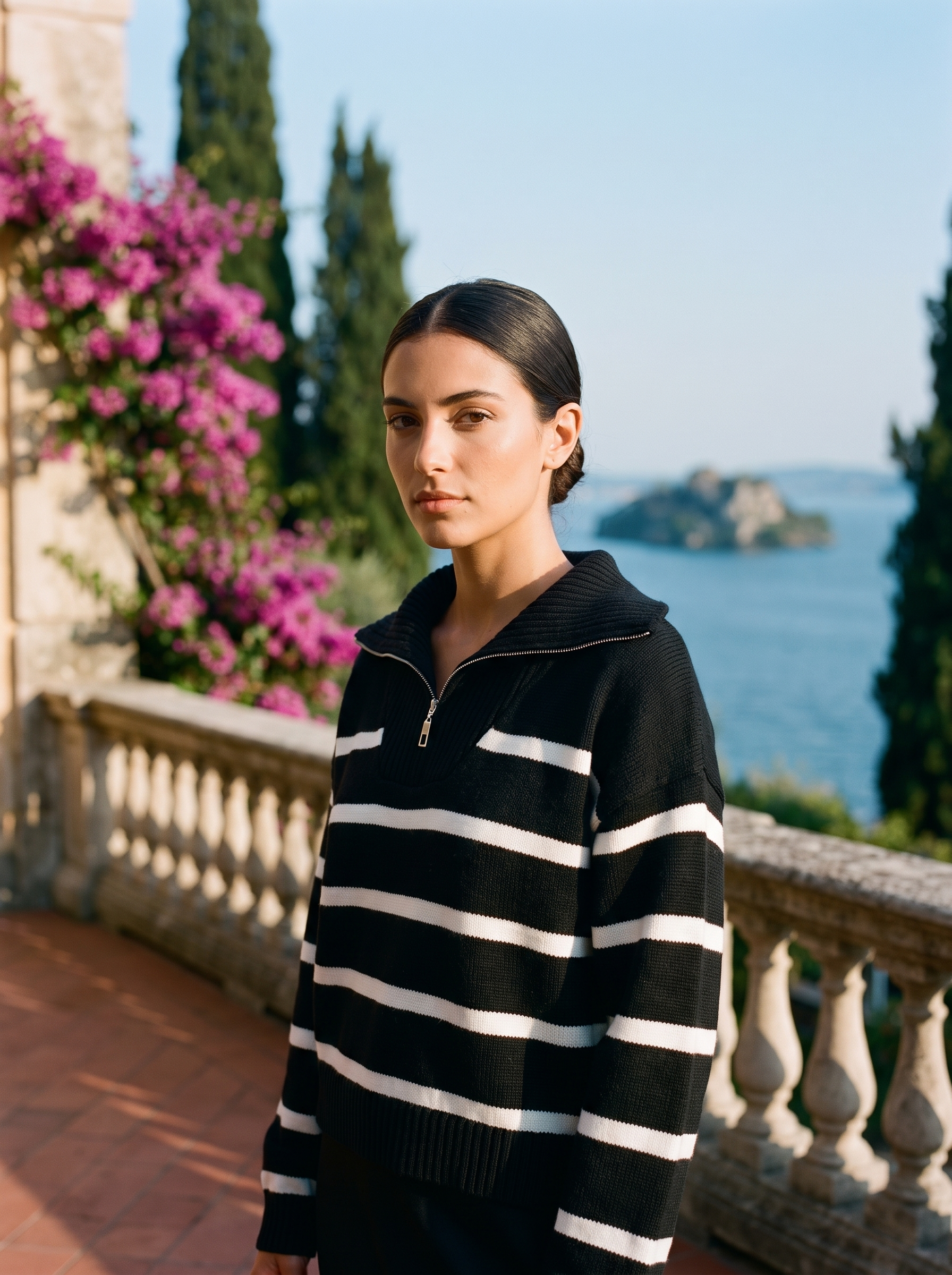 Woman wearing a black and white striped quarter-zip polo sweater on a Lake Como terrace — Aveloire