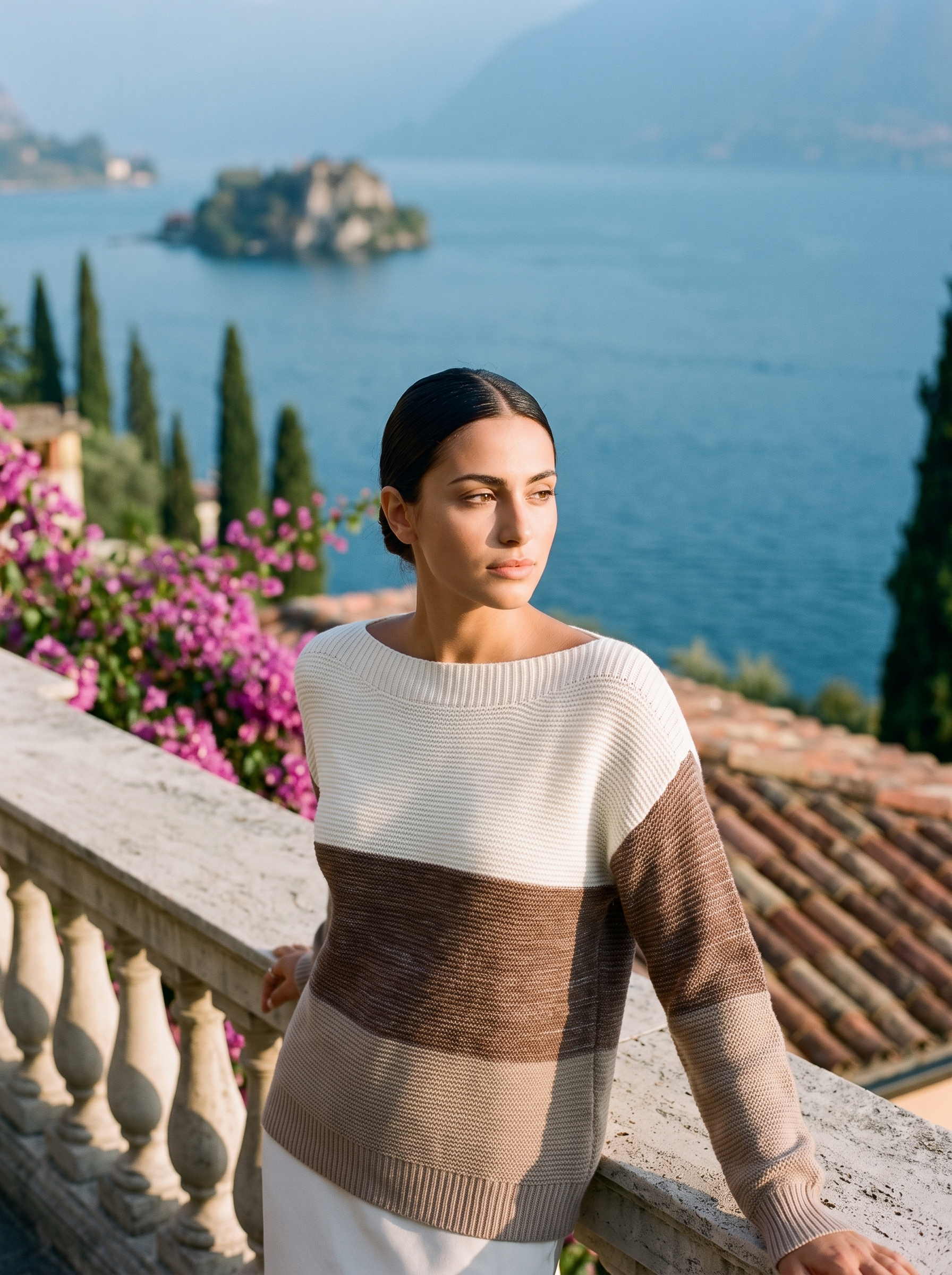 Woman wearing a cream and mocha colour-block boat neck sweater on a Lake Como terrace, old money style — Aveloire