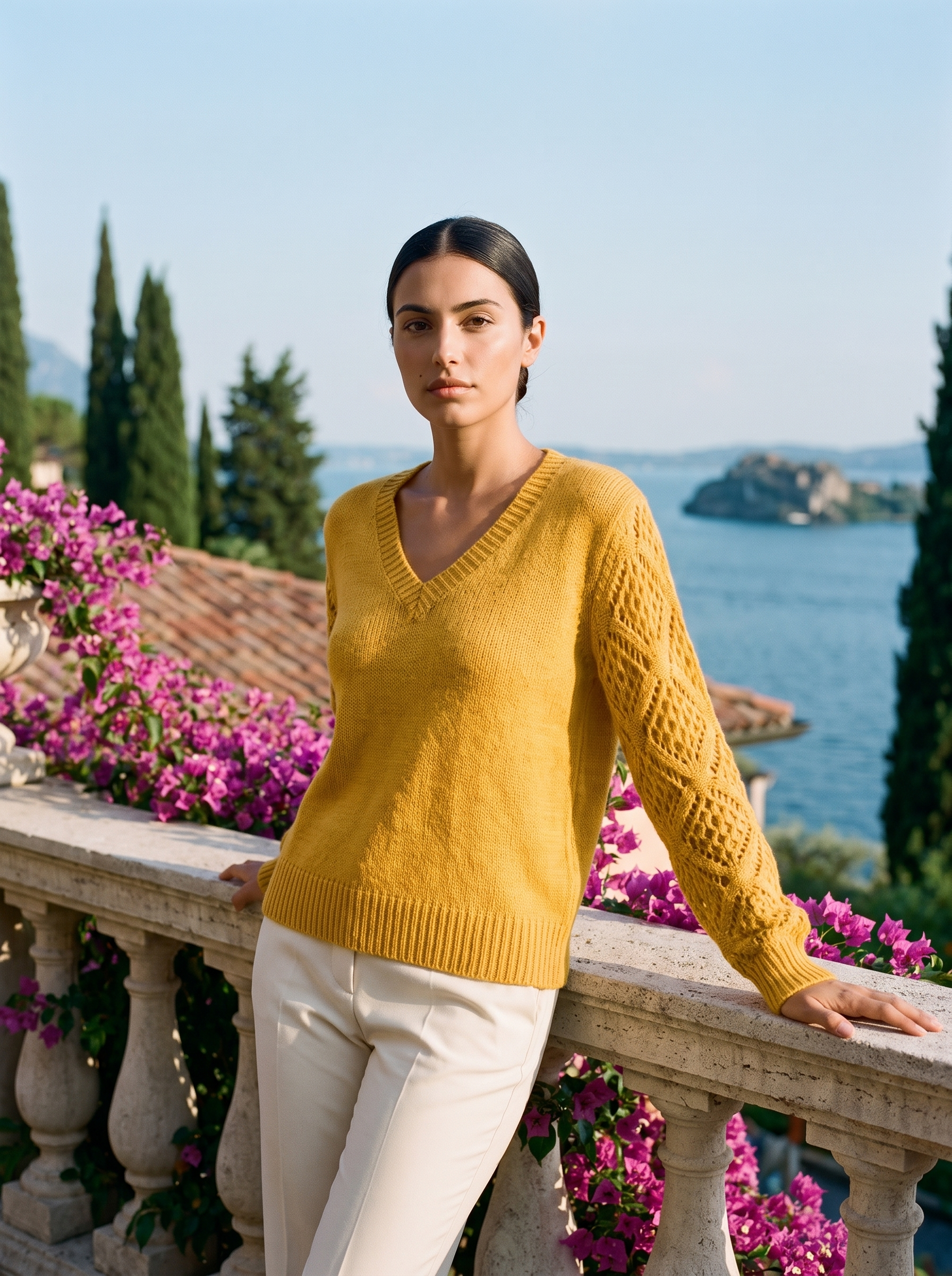 Woman wearing a mustard yellow V-neck knit jumper on a Lake Como terrace, old money style — Aveloire