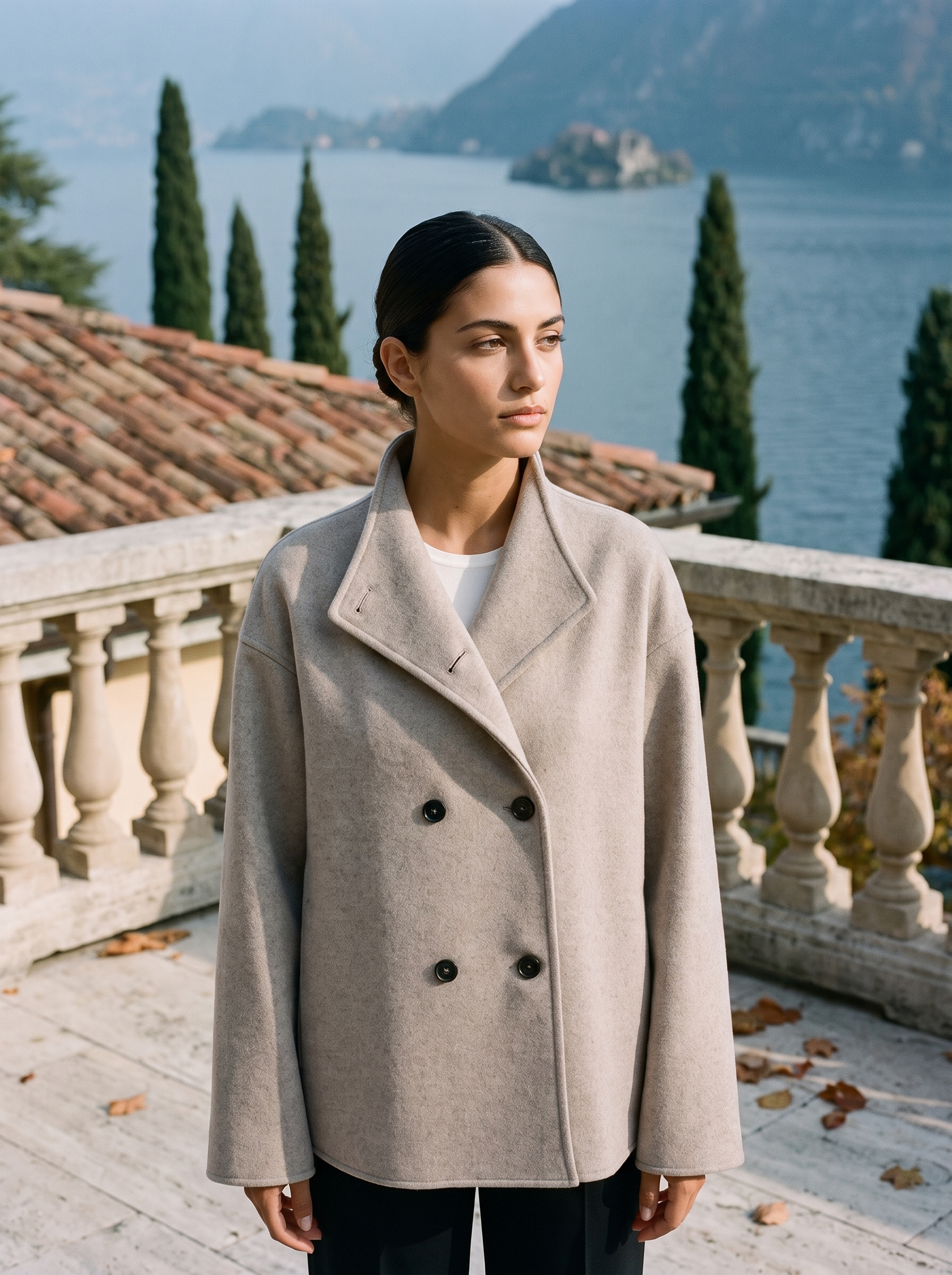 Oatmeal double breasted wool coat for women, worn on a Lake Como terrace — Aveloire