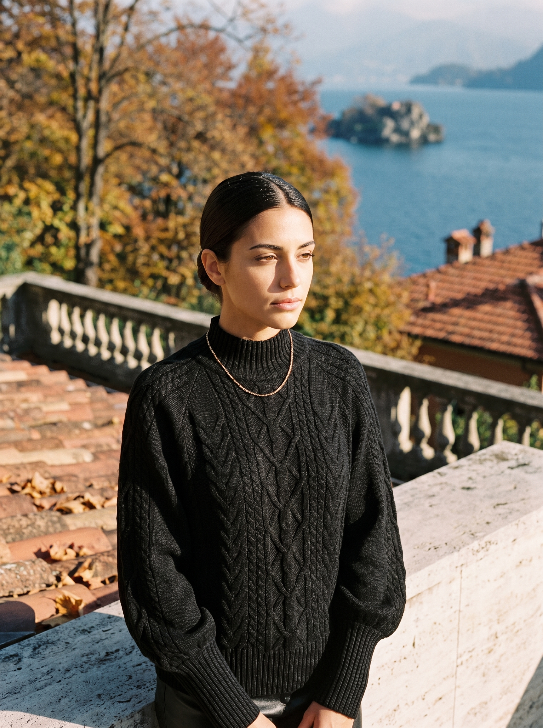 Woman wearing a black cable knit mock neck sweater by Lake Como — Aveloire