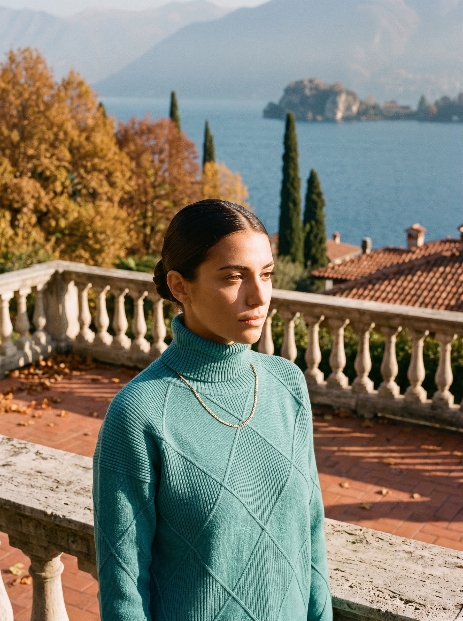 Woman wearing a teal cable knit turtleneck sweater by Lake Como — Aveloire
