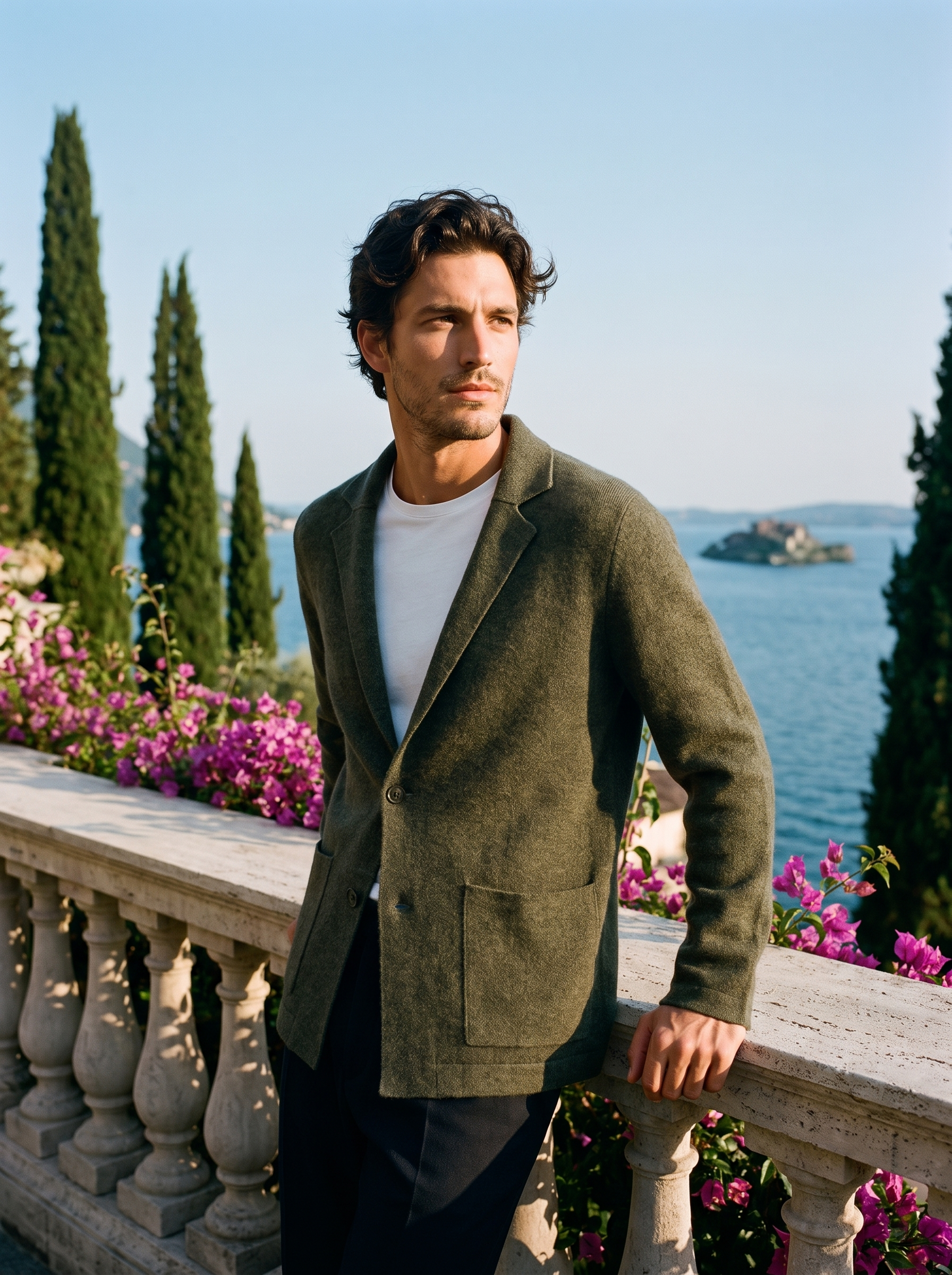 Man wearing an army green wool blazer cardigan on a terrace overlooking Lake Como, old money style — Aveloire