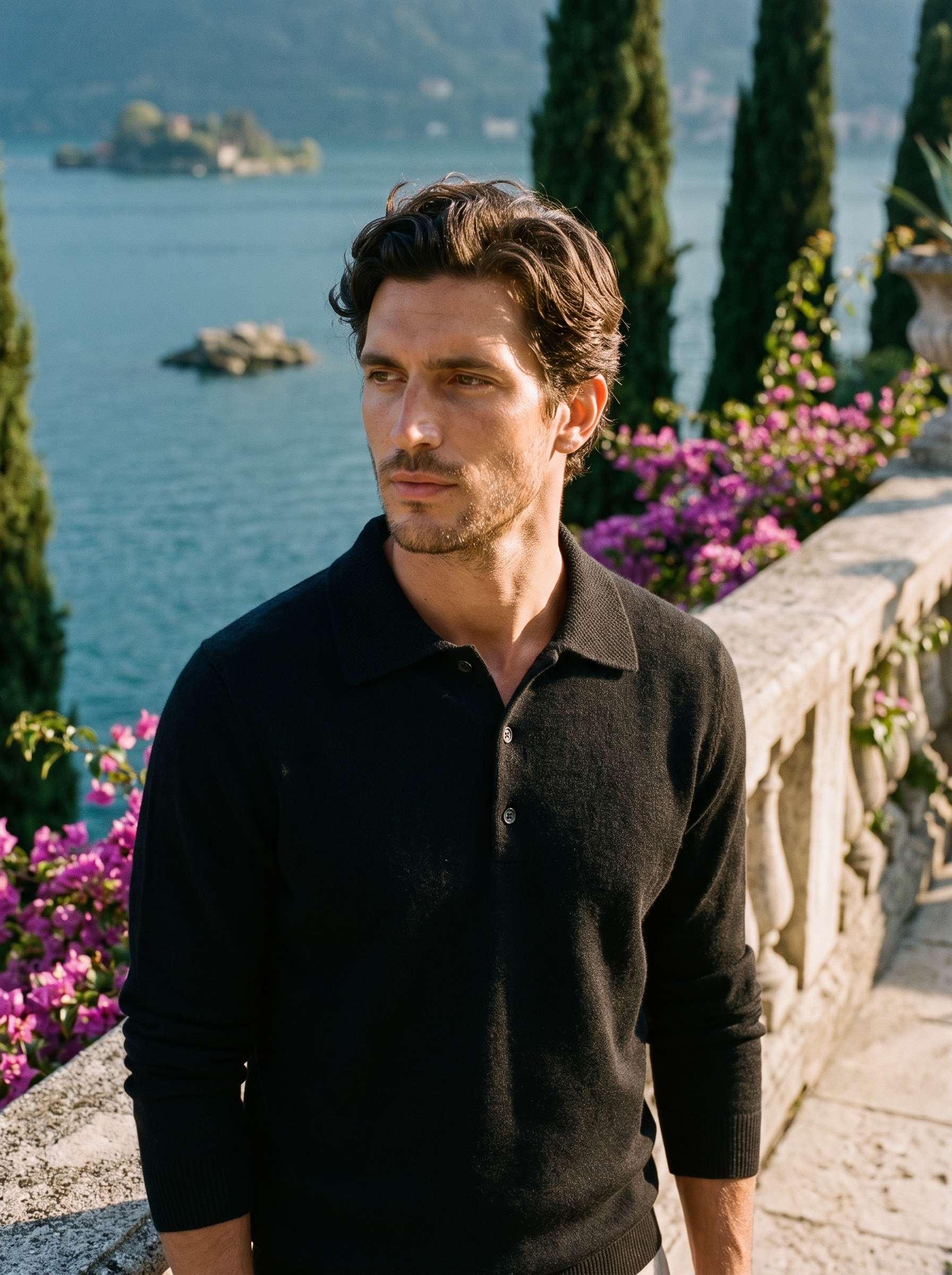 Man wearing a black wool knit polo sweater on a terrace overlooking Lake Como, old money style — Aveloire