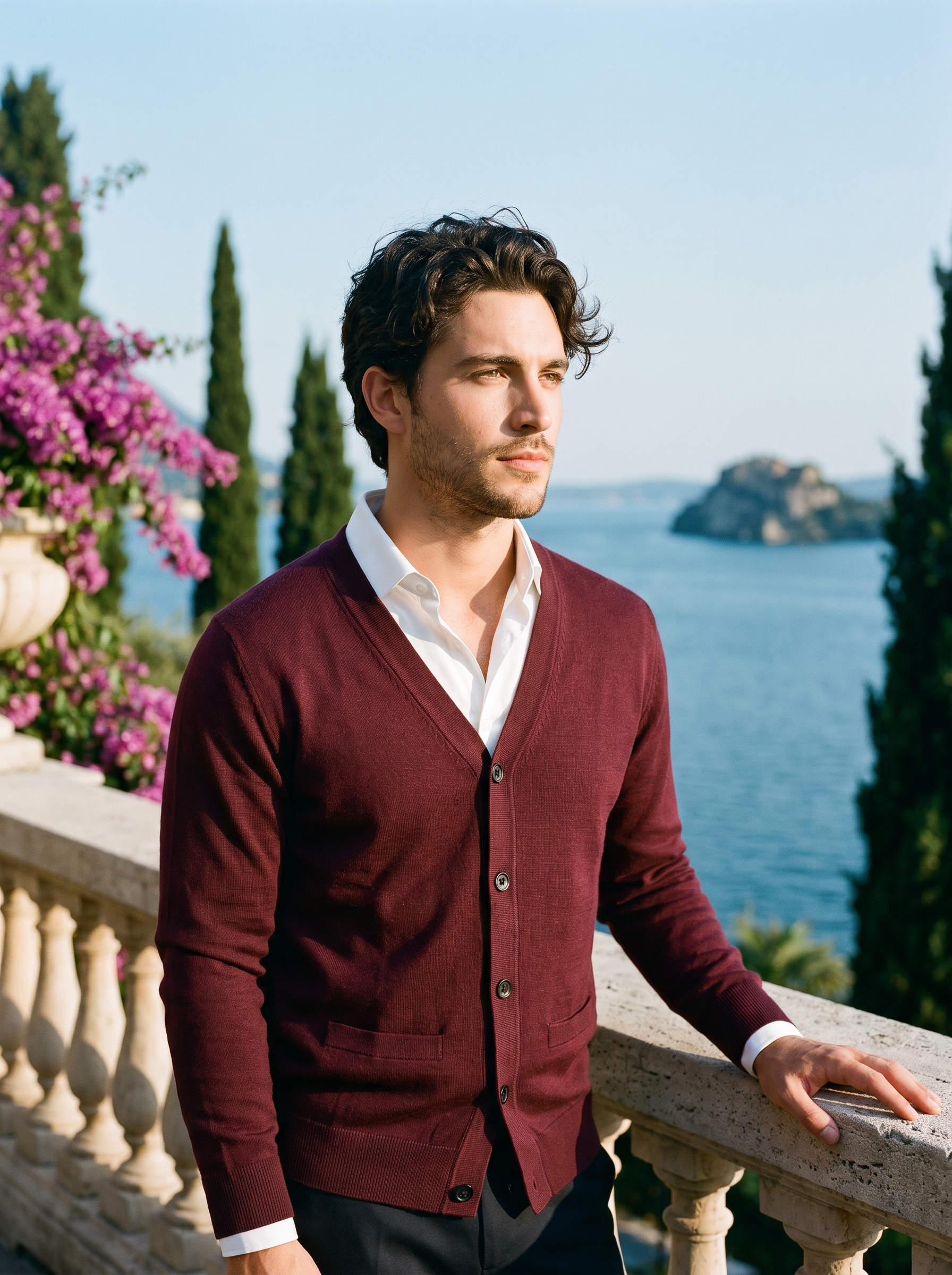 Man wearing a burgundy V-neck button cardigan on a terrace overlooking Lake Como, old money style — Aveloire