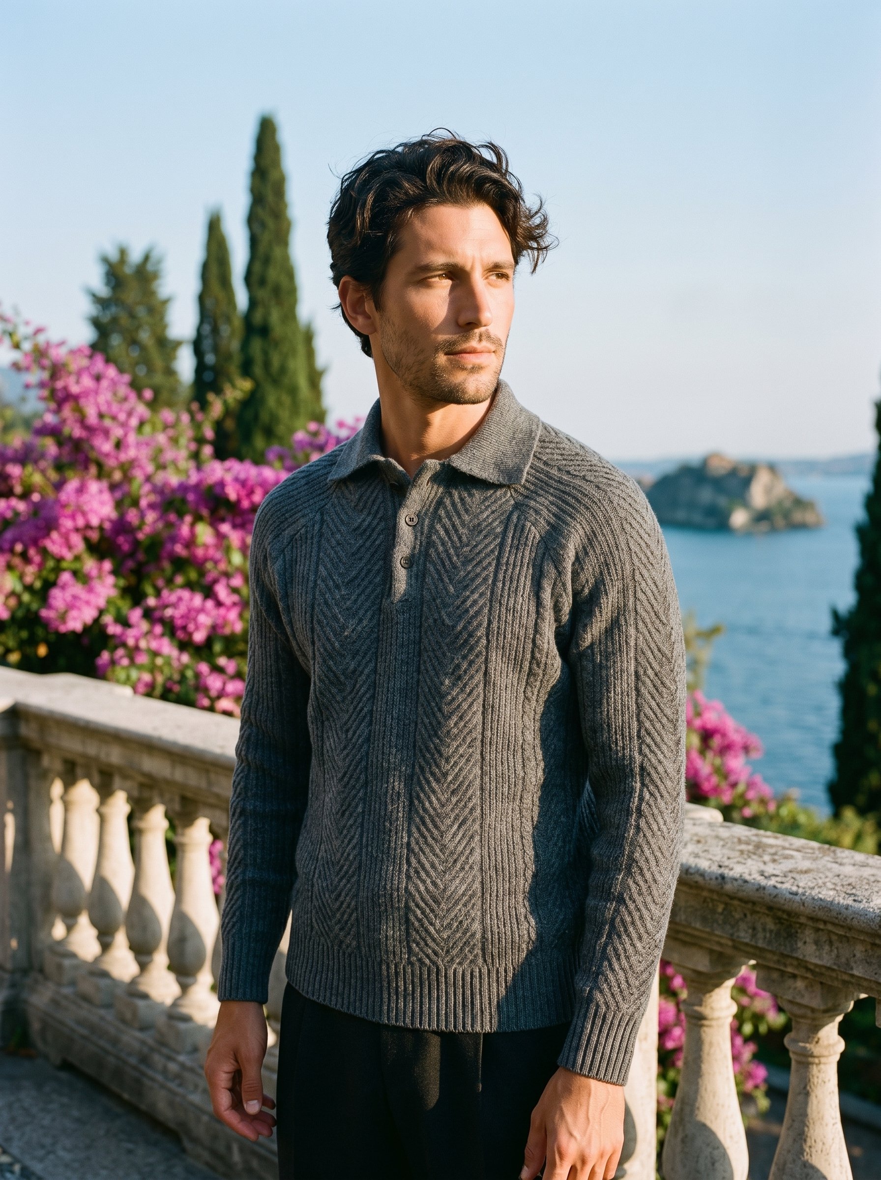 Man wearing a gray herringbone knit polo sweater on a terrace overlooking Lake Como, old money style — Aveloire