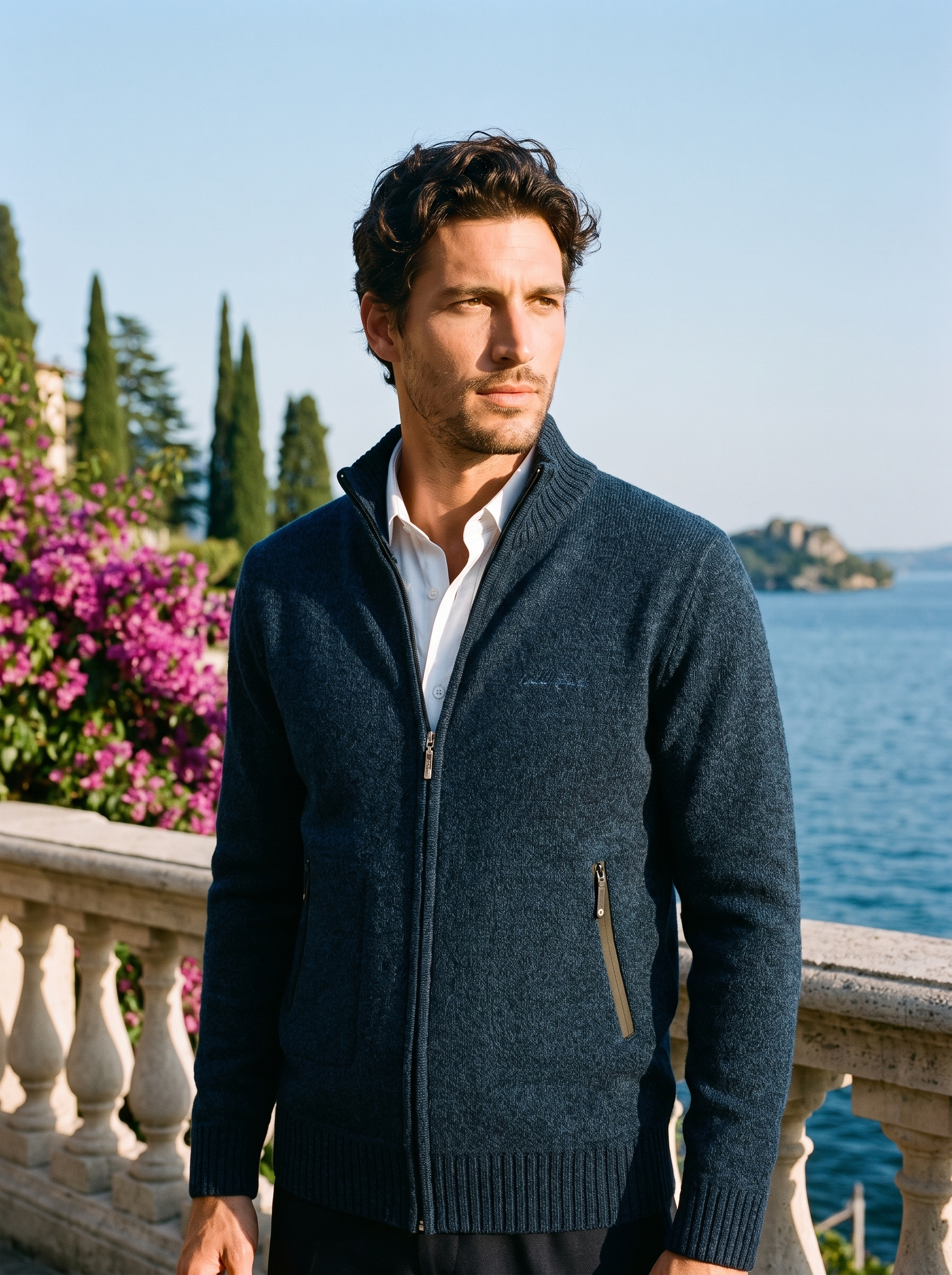 Man wearing a navy melange zip-up stand collar cardigan on a terrace overlooking Lake Como, old money style — Aveloire