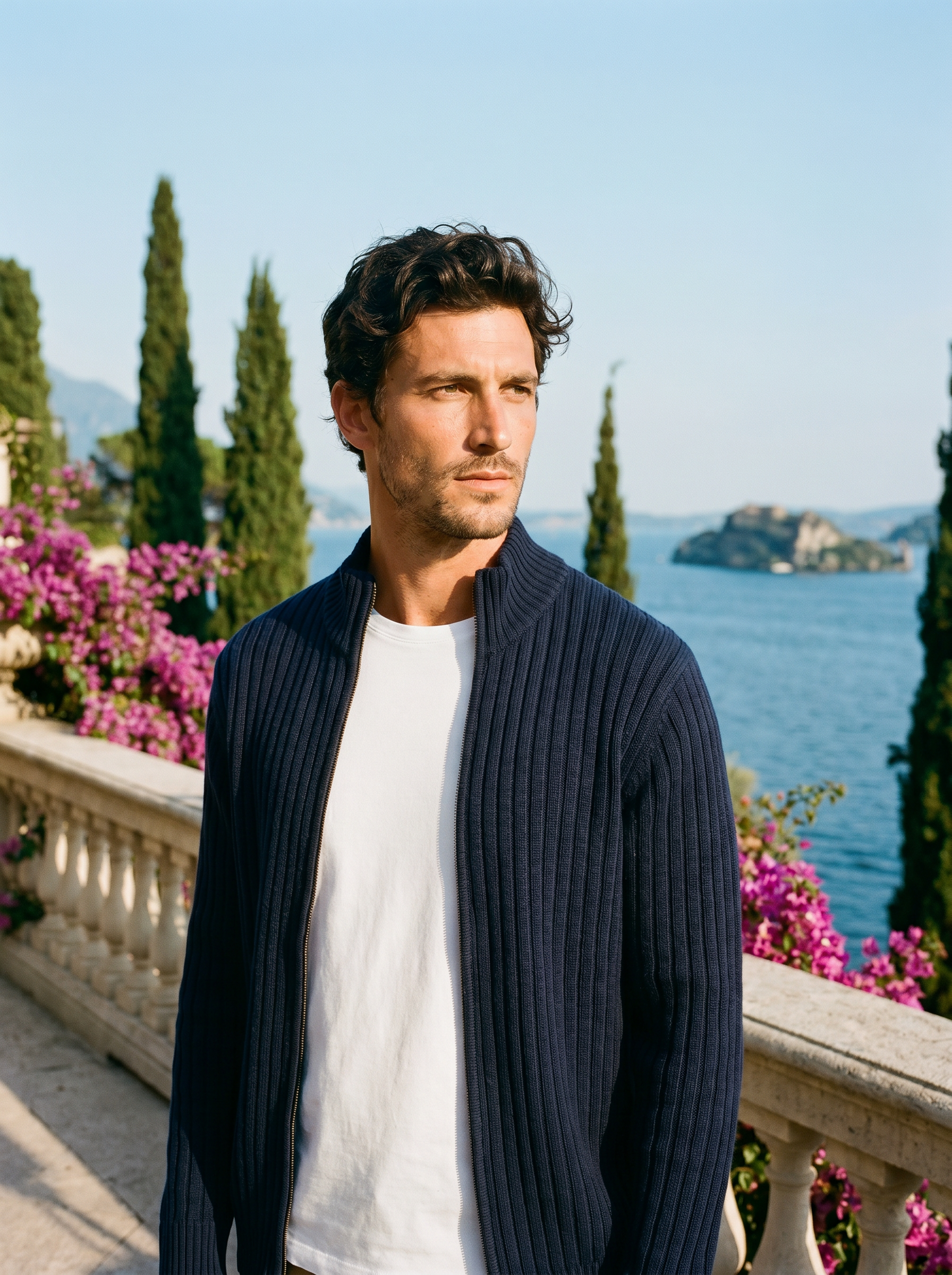 Man wearing a navy ribbed cotton full-zip cardigan on a terrace overlooking Lake Como, old money style — Aveloire