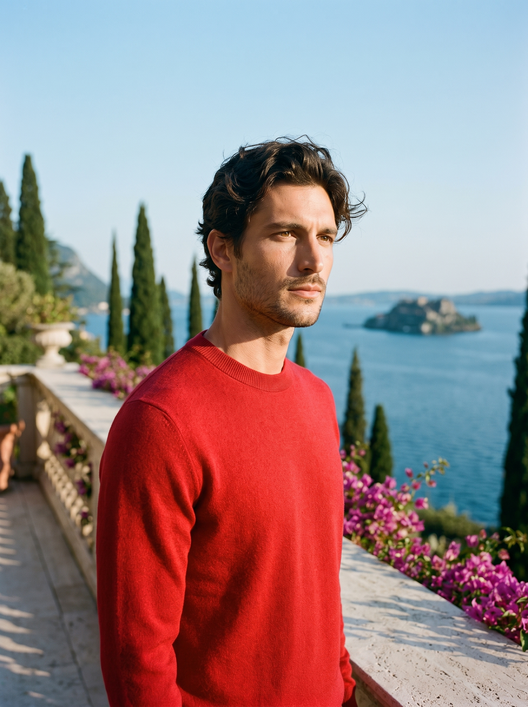 Man wearing a red 100% wool crewneck sweater on a terrace overlooking Lake Como, old money style — Aveloire