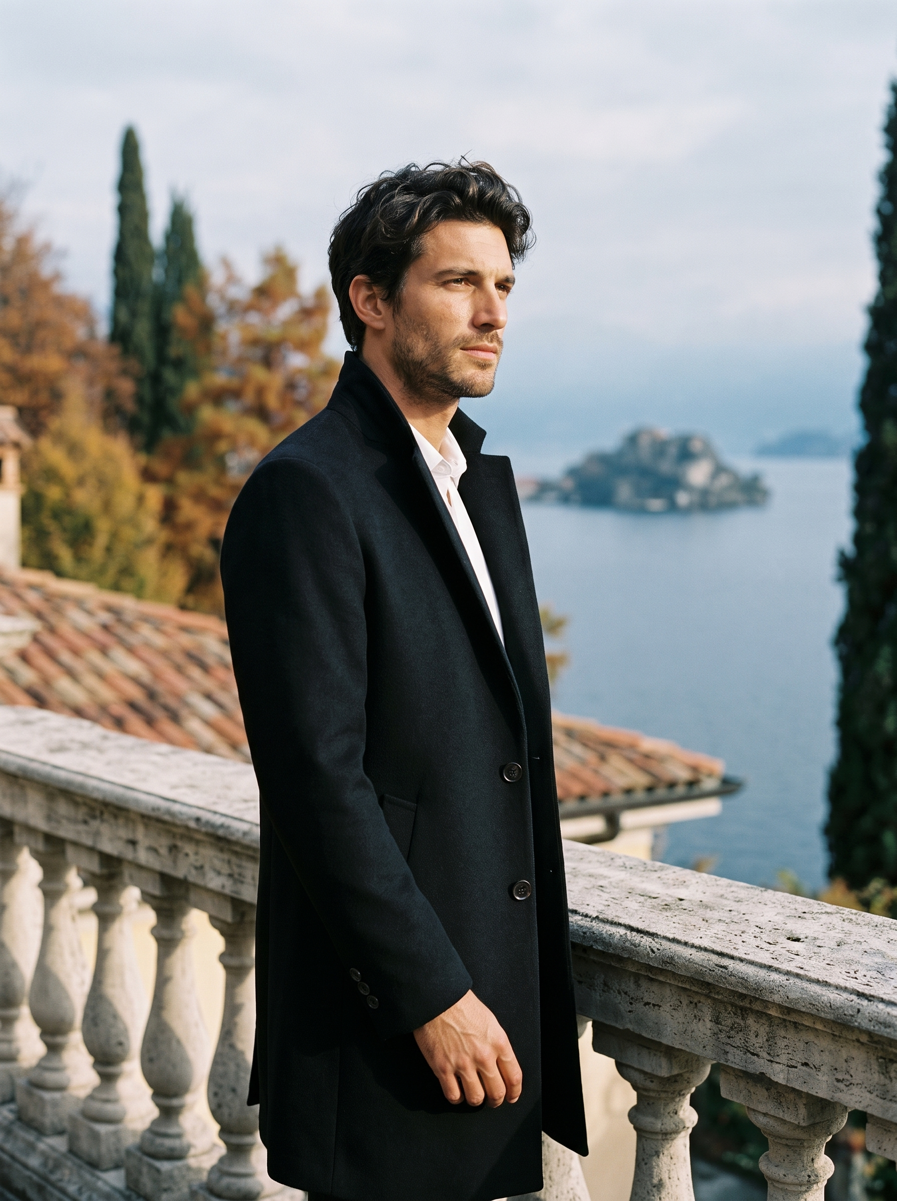 Black stand collar overcoat for men, worn on a Lake Como terrace — Aveloire