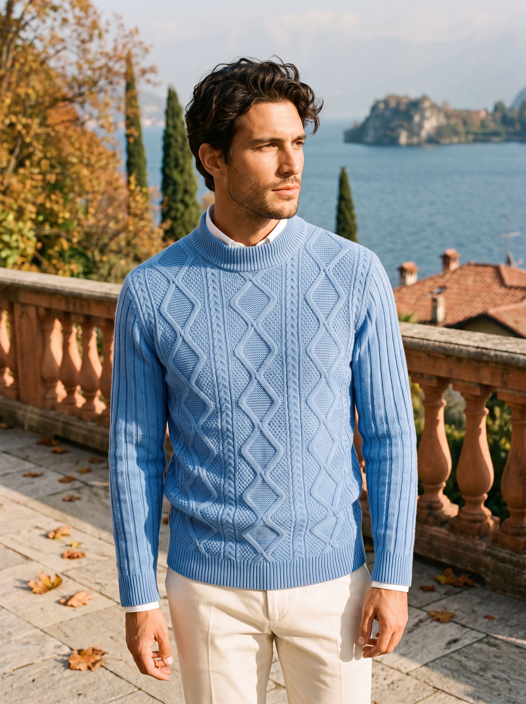 Man wearing a light blue cable knit mock neck sweater on a terrace by Lake Como - Aveloire