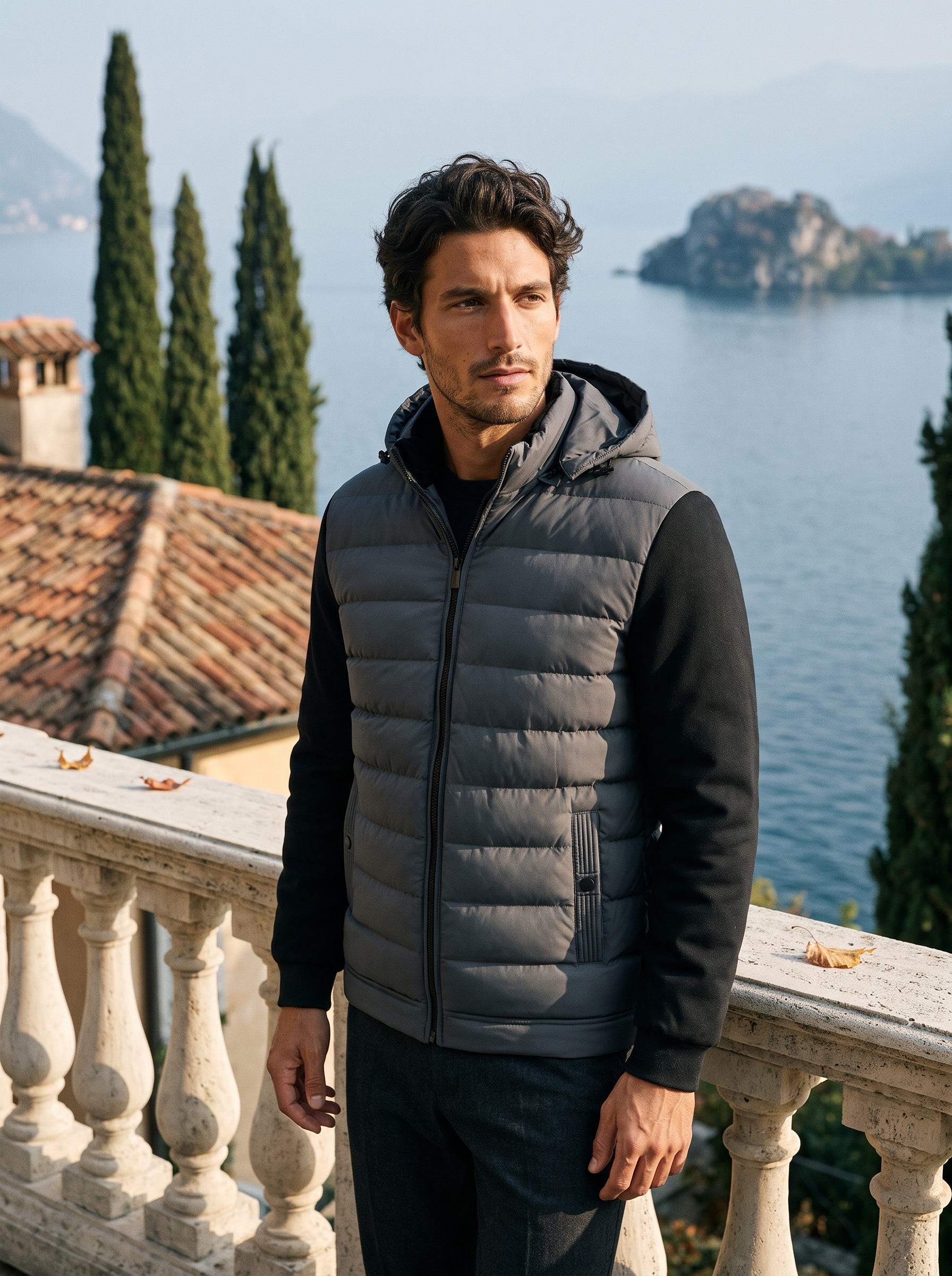 Gray down puffer jacket for men with contrast darker sleeves, worn on a Lake Como terrace — Aveloire