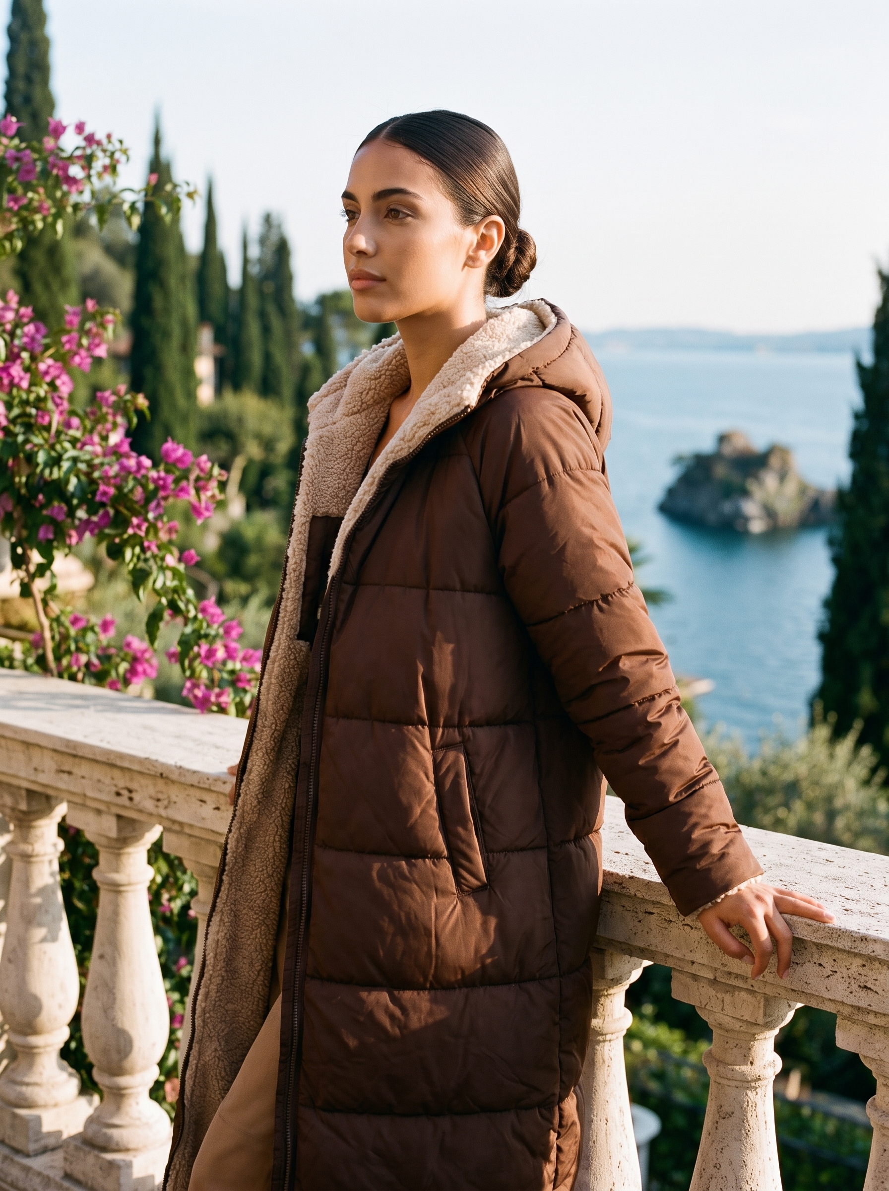 Woman wearing brown puffer coat on a Lake Como terrace — Aveloire