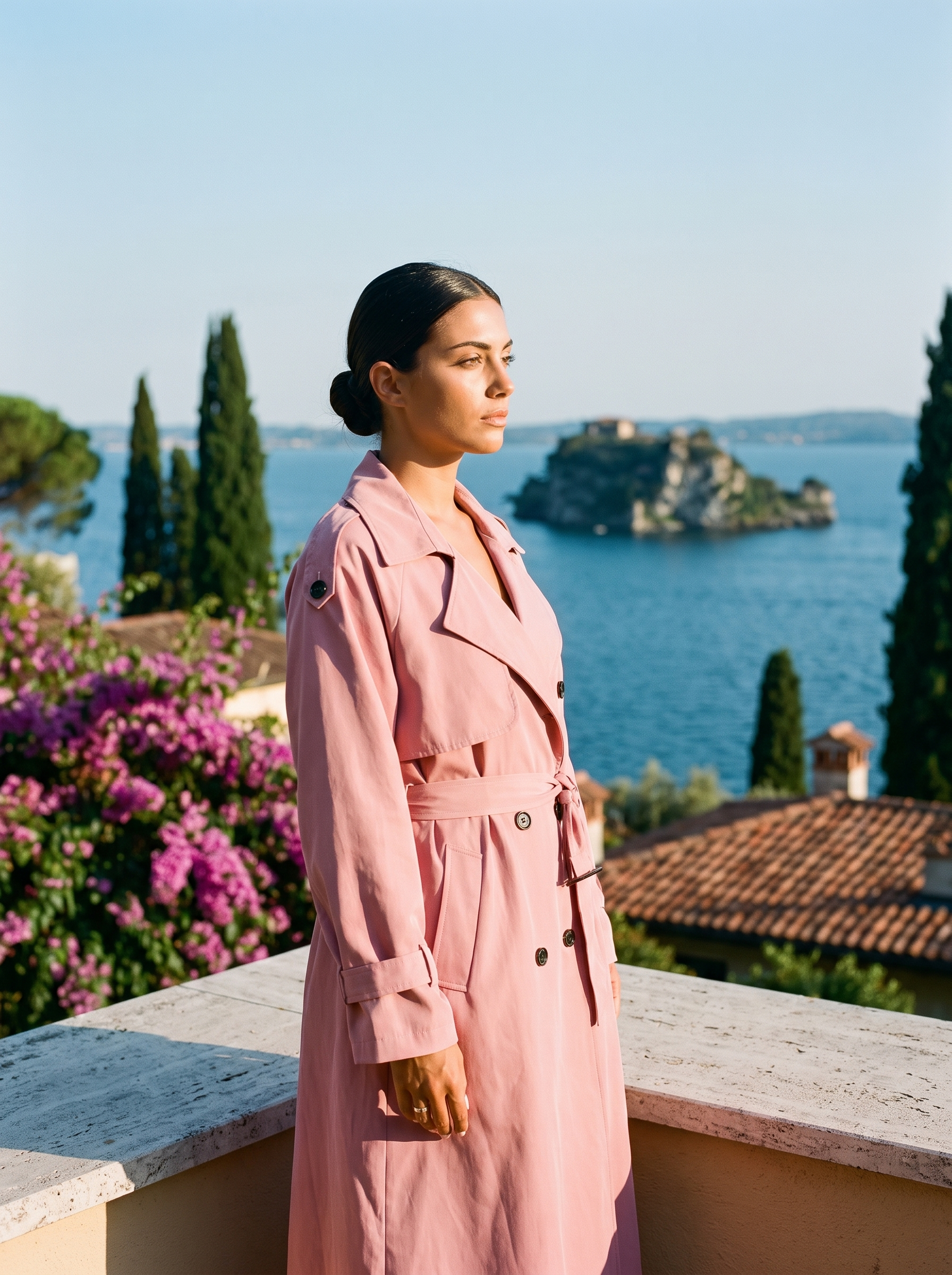 Woman wearing pink lightweight trench coat on a Lake Como terrace — Aveloire