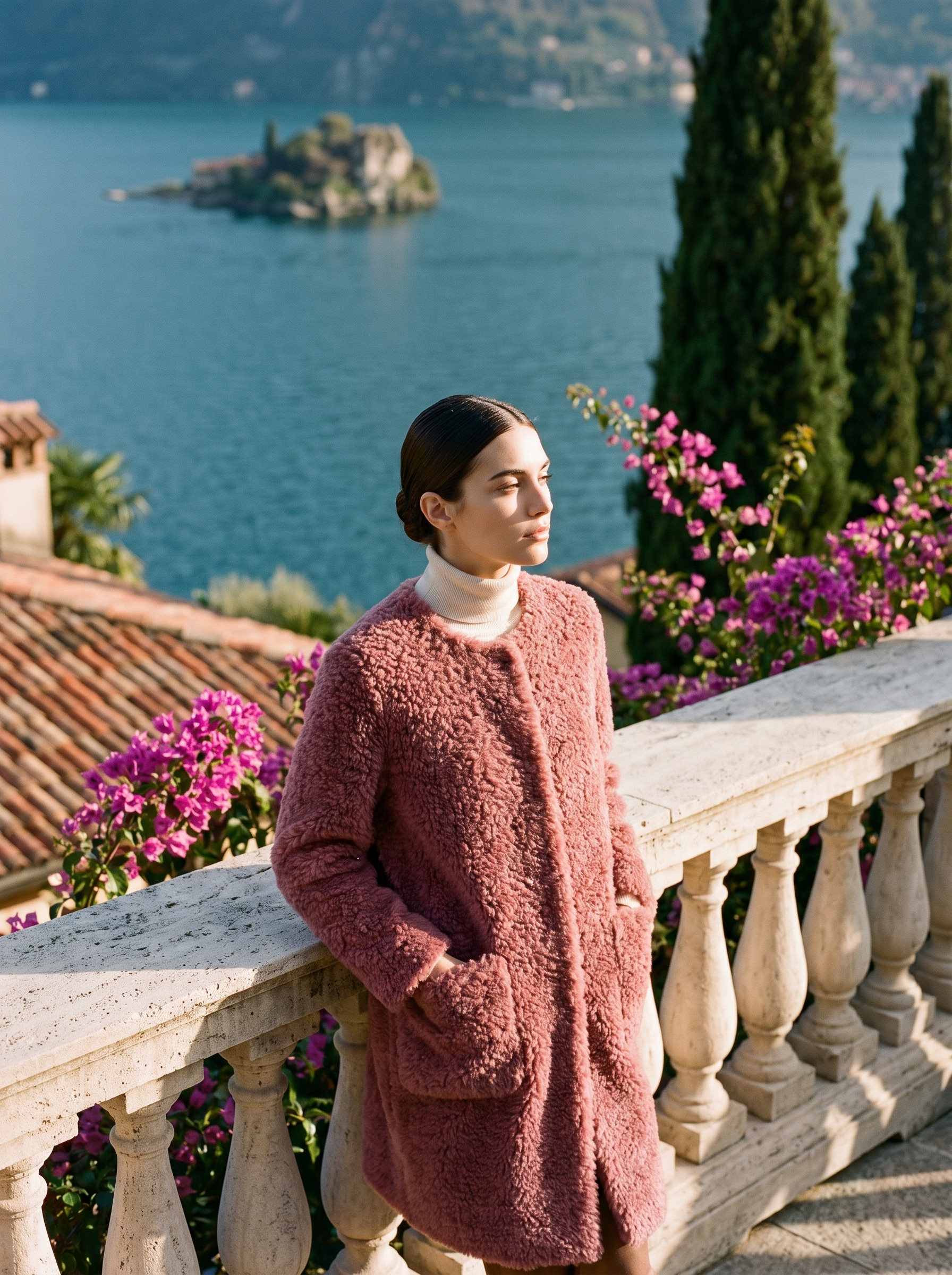 Woman wearing a dusty-rosewood shearling teddy coat on a Lake Como terrace — Aveloire